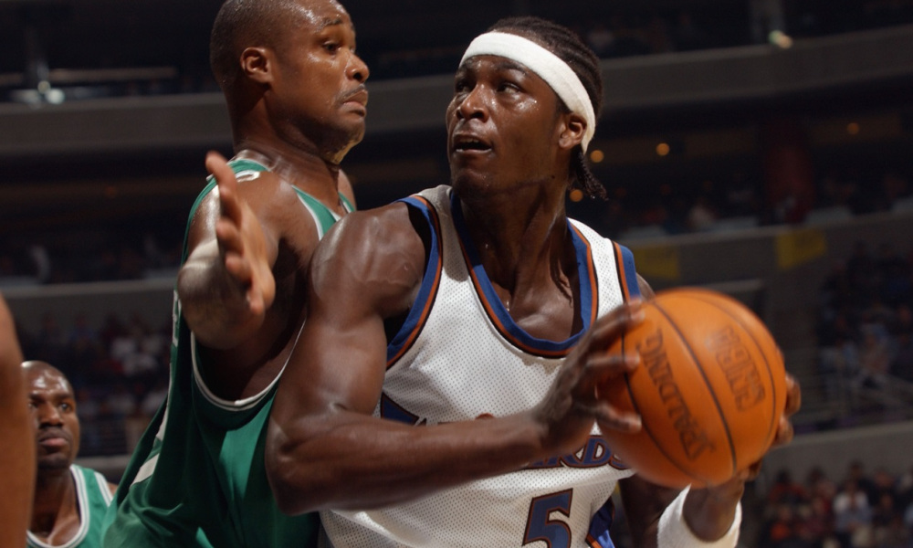 WASHINGTON - OCTOBER 31:  Kwame Brown #5 of the Washington Wizards is defended by Antoine Walker #8 of the Boston Celtics during the game at MCI Center on October 31, 2002 in Washington, D.C.  The Wizards won 114-69.  NOTE TO USER: User expressly acknowledges and agrees that, by downloading and/or using this Photograph, User is consenting to the terms and conditions of the Getty Images License Agreement (Photo by Doug Pensinger/Getty Images)