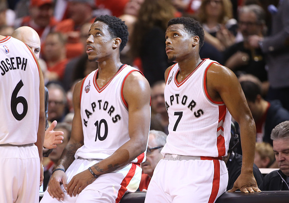TORONTO, CANADA - APRIL 16: Kyle Lowry #7 (R) of the Toronto Raptors and DeMar DeRozan #10 (L) look on against the Indiana Pacers in Game One of the Eastern Conference Quarterfinals during the 2016 NBA Playoffs on April 16, 2016 at the Air Canada Centre in Toronto, Ontario, Canada. NOTE TO USER: User expressly acknowledges and agrees that, by downloading and or using this photograph, User is consenting to the terms and conditions of the Getty Images License Agreement. (Photo by Tom Szczerbowski/Getty Images)