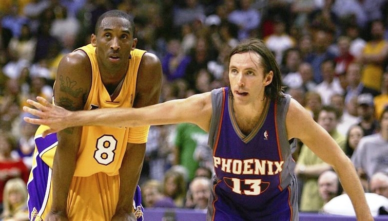 LOS ANGELES - MAY 4:  Steve Nash #13 of the Phoenix Suns puts his arm in front of Kobe Bryant #8 of the Los Angeles Lakers in game six of the Western Conference Quarterfinals during the 2006 NBA Playoffs on May 4, 2006 at the Staples Center in Los Angeles, California. The Suns defeated the Lakers 126-118 in overtime to tie the series 3-3.  NOTE TO USER: User expressly acknowledges and agrees that, by downloading and/or using this Photograph, user is consenting to the terms and conditions of the Getty Images License Agreement.  (Photo by Harry How/Getty Images)