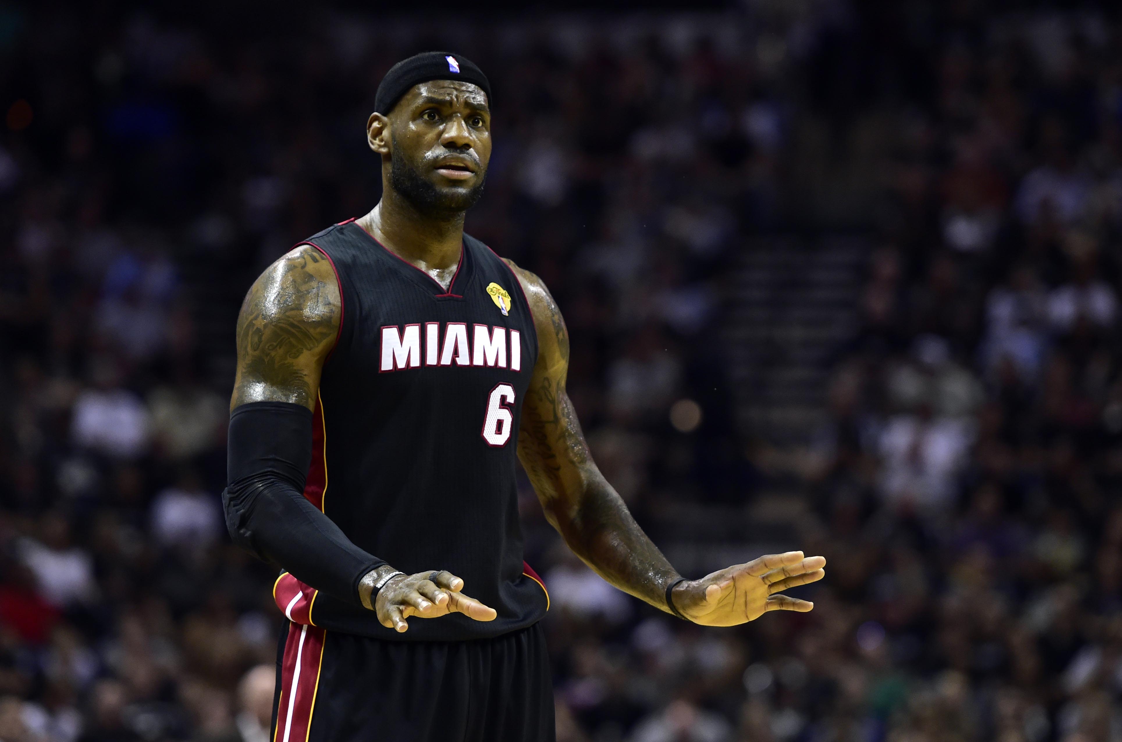 Miami Heat forward LeBron James (6) talks to his team at the American Airlines Arena.