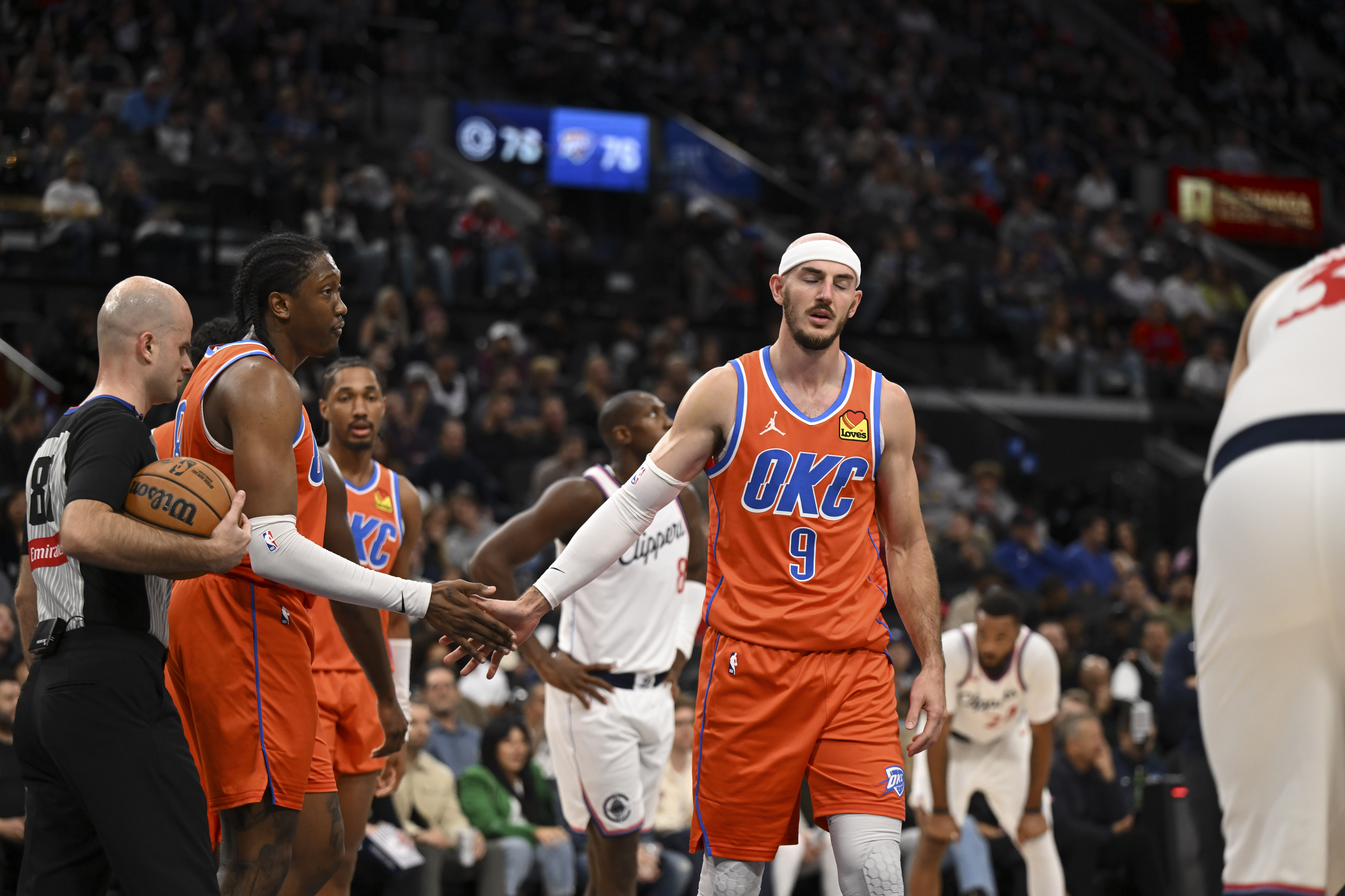 Nov 2, 2024; Inglewood, California, USA; Oklahoma City Thunder guard Alex Caruso (9) fives his teammates against the LA Clippers during the second half at Intuit Dome.
