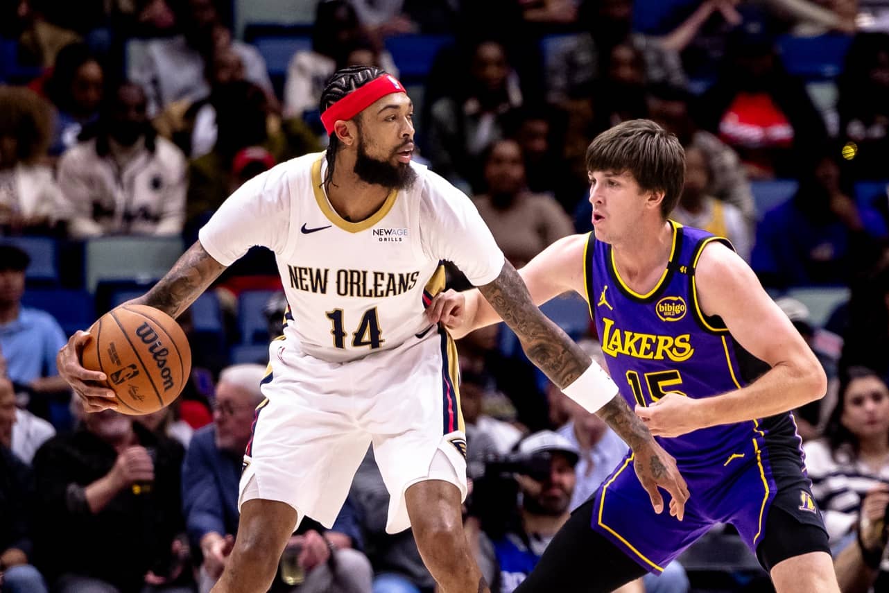Nov 16, 2024; New Orleans, Louisiana, USA; New Orleans Pelicans forward Brandon Ingram (14) dribbles against Los Angeles Lakers guard Austin Reaves (15) during the first half at Smoothie King Center. Mandatory Credit: Stephen Lew-Imagn Images  