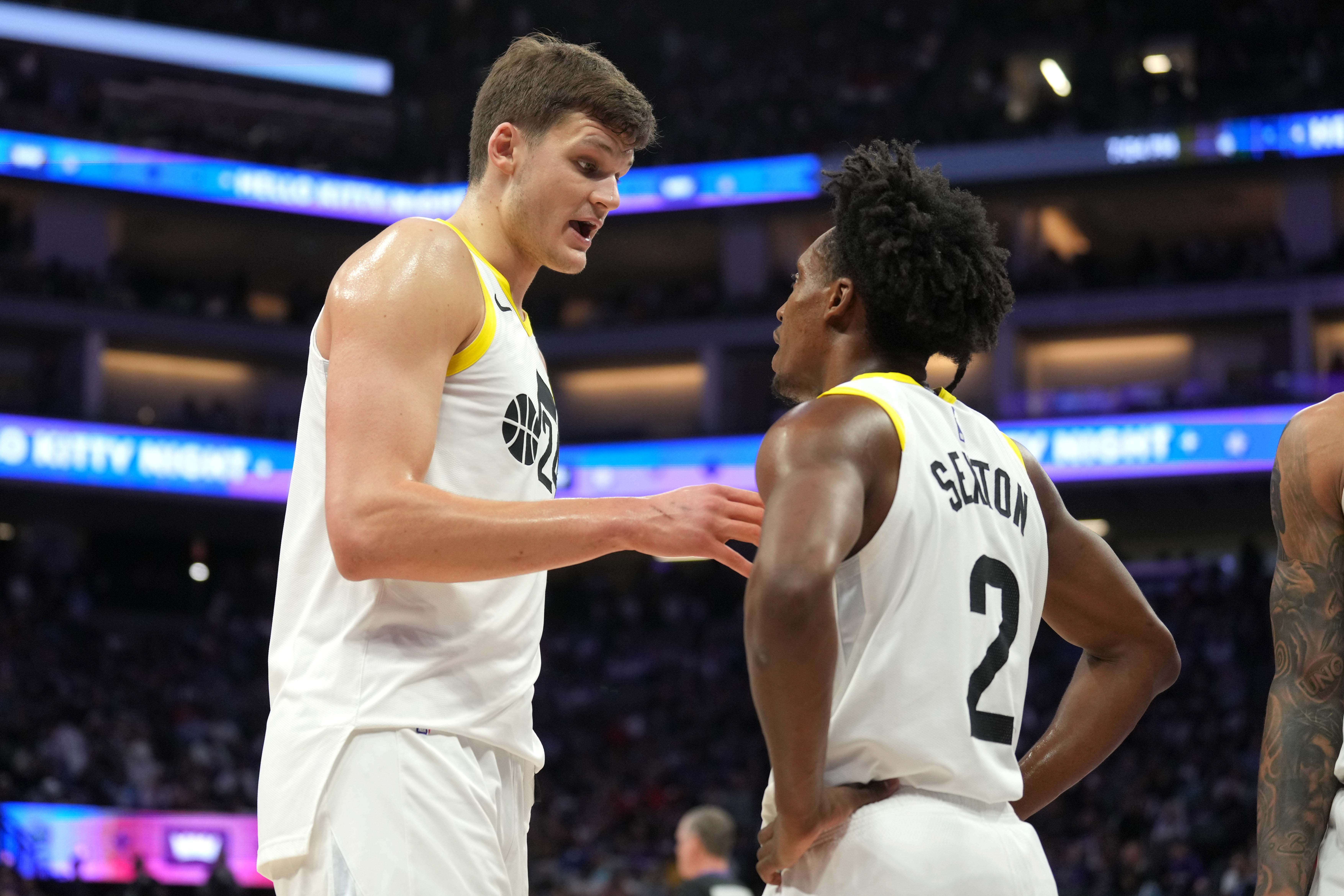 Utah Jazz center Walker Kessler (left) talks with guard Collin Sexton (2) during halftime against the Sacramento Kings at Golden 1 Center.