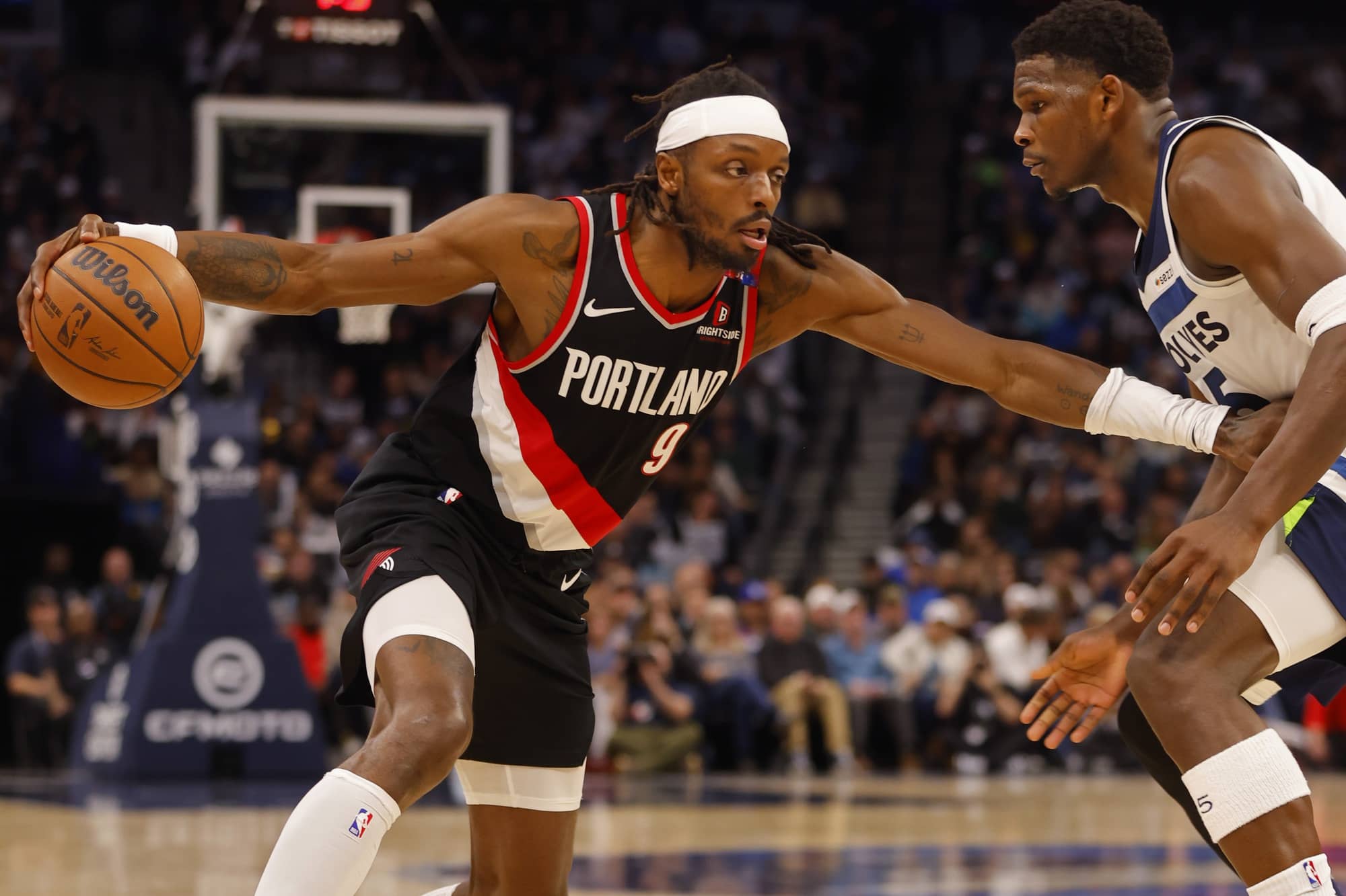 Nov 8, 2024; Minneapolis, Minnesota, USA; Portland Trail Blazers forward Jerami Grant (9) works against Minnesota Timberwolves guard Anthony Edwards (5) in the third quarter at Target Center. Mandatory Credit: Bruce Kluckhohn-Imagn Images  