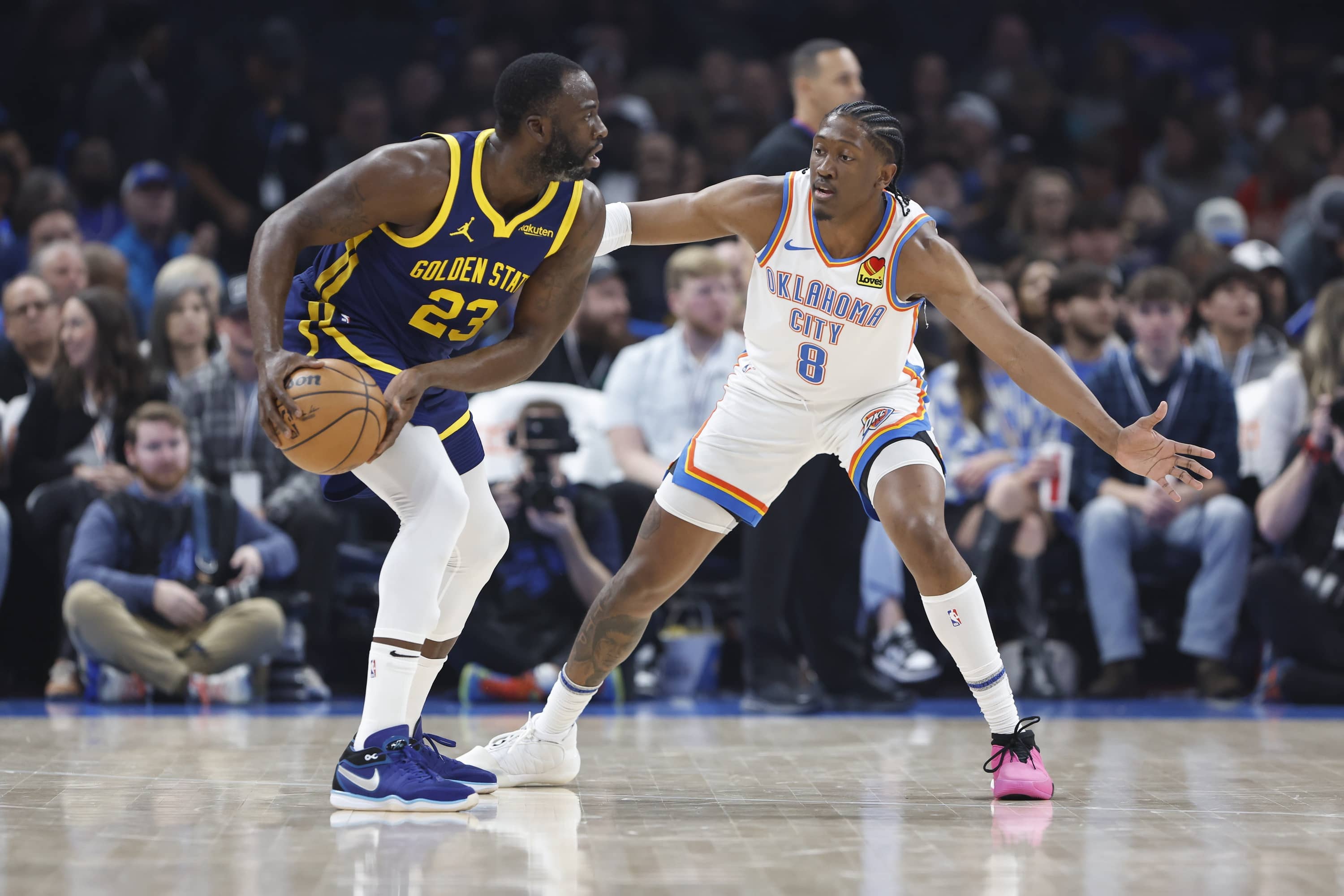 Dec 8, 2023; Oklahoma City, Oklahoma, USA; Oklahoma City Thunder forward Jalen Williams (8) defends Golden State Warriors forward Draymond Green (23) during the first quarter at Paycom Center.