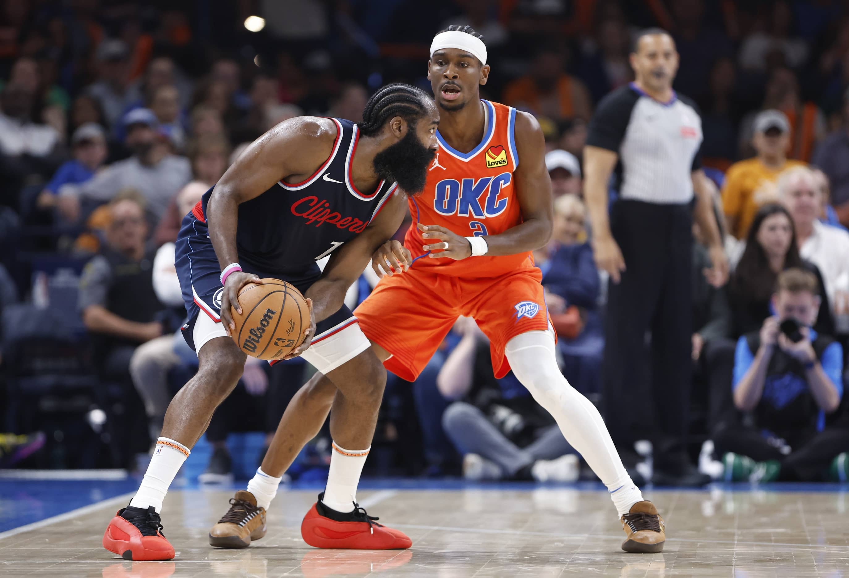 Nov 11, 2024; Oklahoma City, Oklahoma, USA; Oklahoma City Thunder guard Shai Gilgeous-Alexander (2) defends a drive by Los Angeles Clippers guard James Harden (1) during the second quarter at Paycom Center.