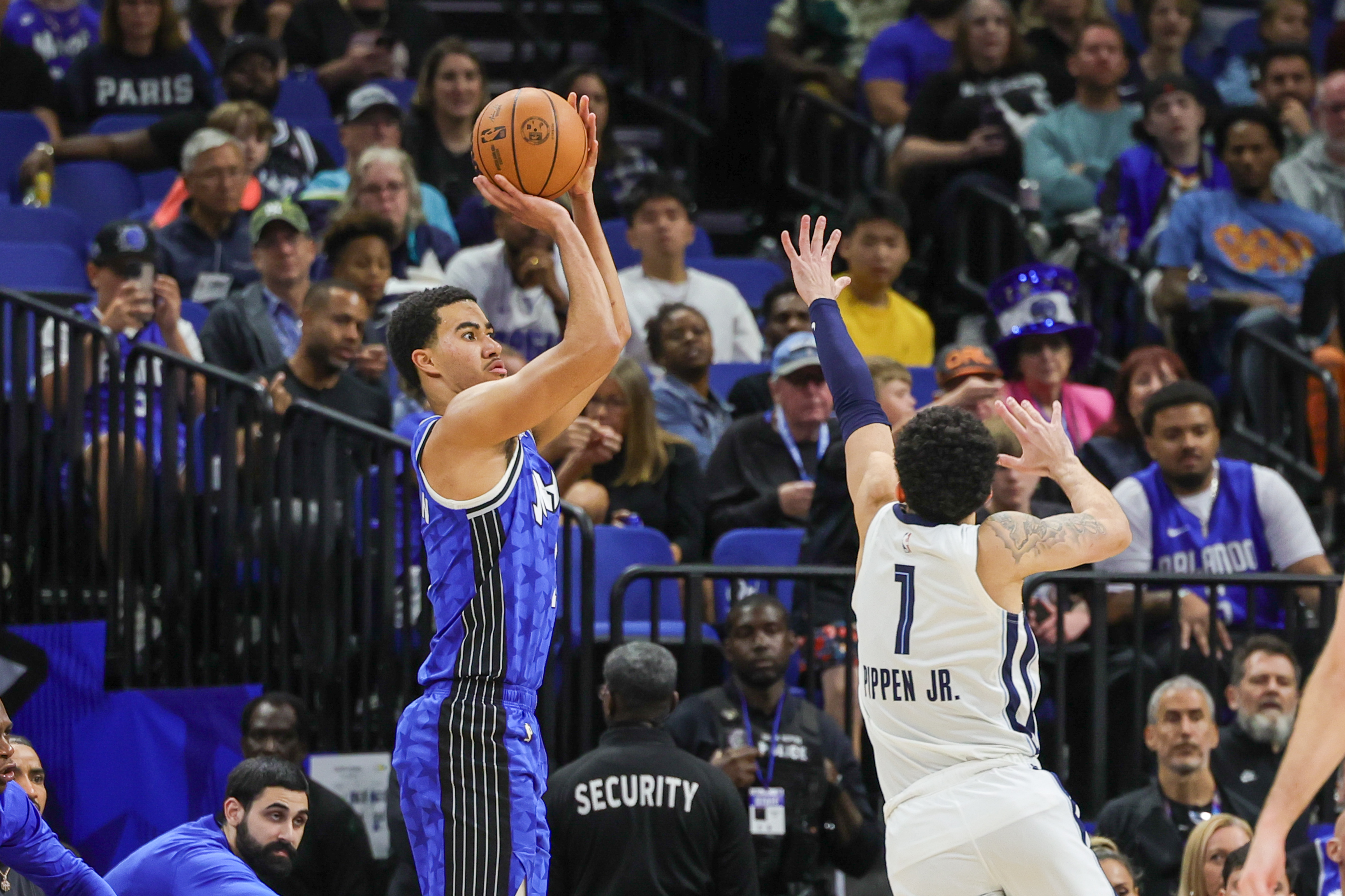 Mar 30, 2024; Orlando, Florida, USA; Orlando Magic guard Caleb Houstan (2) shoots a three point basket over Memphis Grizzlies guard Scotty Pippen Jr. (1) during the second half at KIA Center.