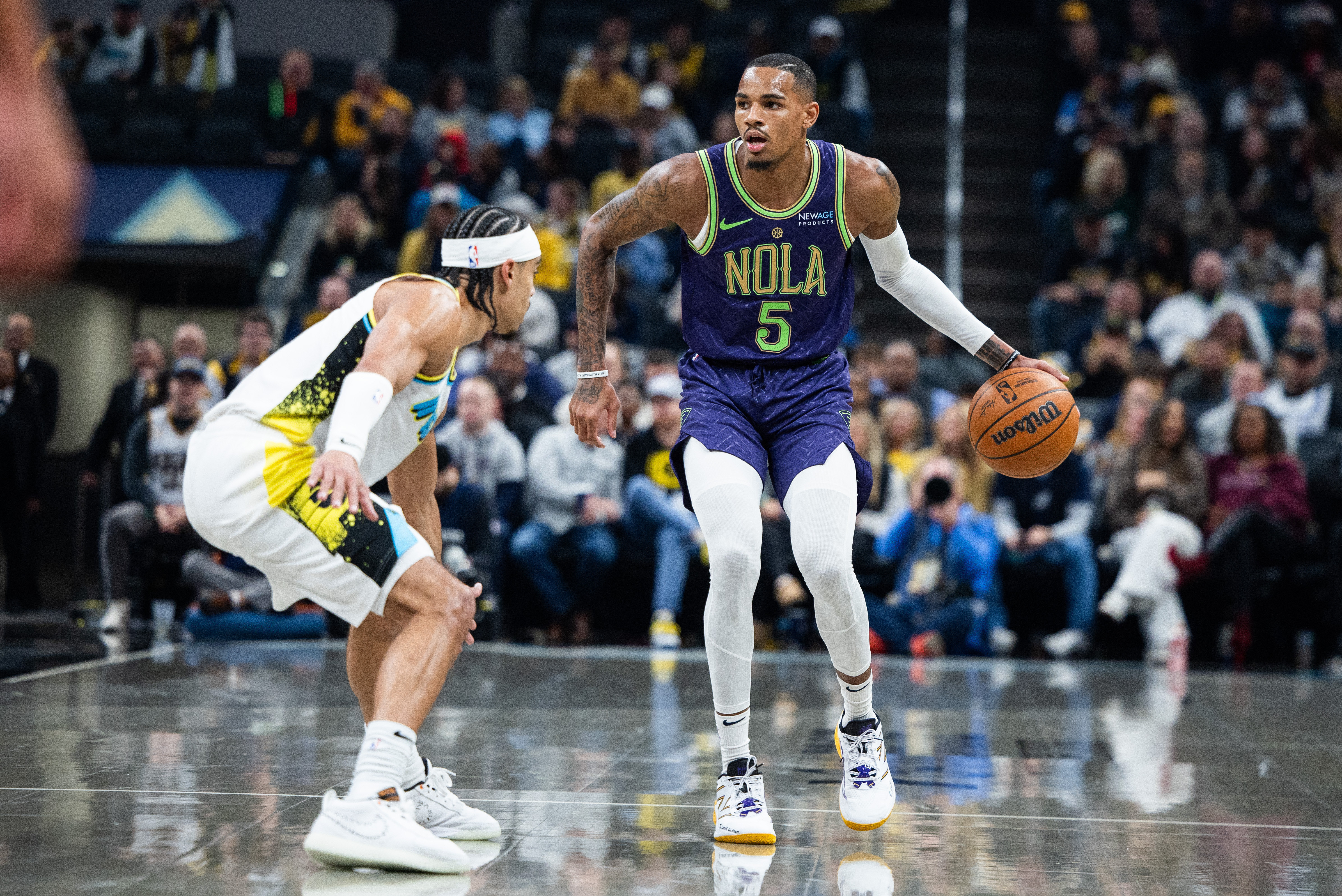 Dec 15, 2024; Indianapolis, Indiana, USA; New Orleans Pelicans guard Dejounte Murray (5) dribbles the ball while Indiana Pacers guard Andrew Nembhard (2) defends in the first half at Gainbridge Fieldhouse. Mandatory Credit: Trevor Ruszkowski-Imagn Images  