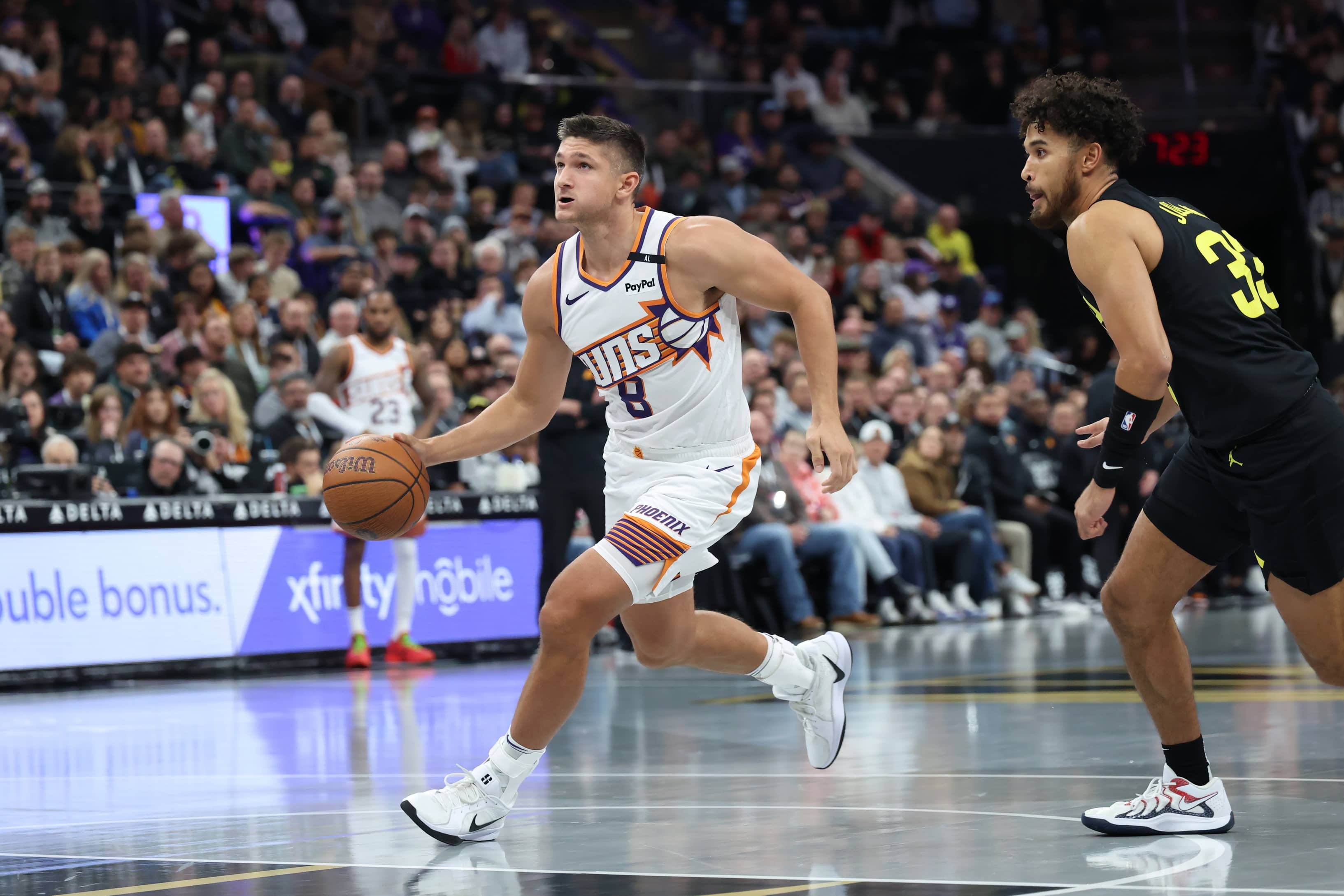 Nov 12, 2024; Salt Lake City, Utah, USA; Phoenix Suns guard Grayson Allen (8) goes to the basket against Utah Jazz guard Johnny Juzang (33) during the first quarter at Delta Center. Mandatory Credit: Rob Gray-Imagn Images  
