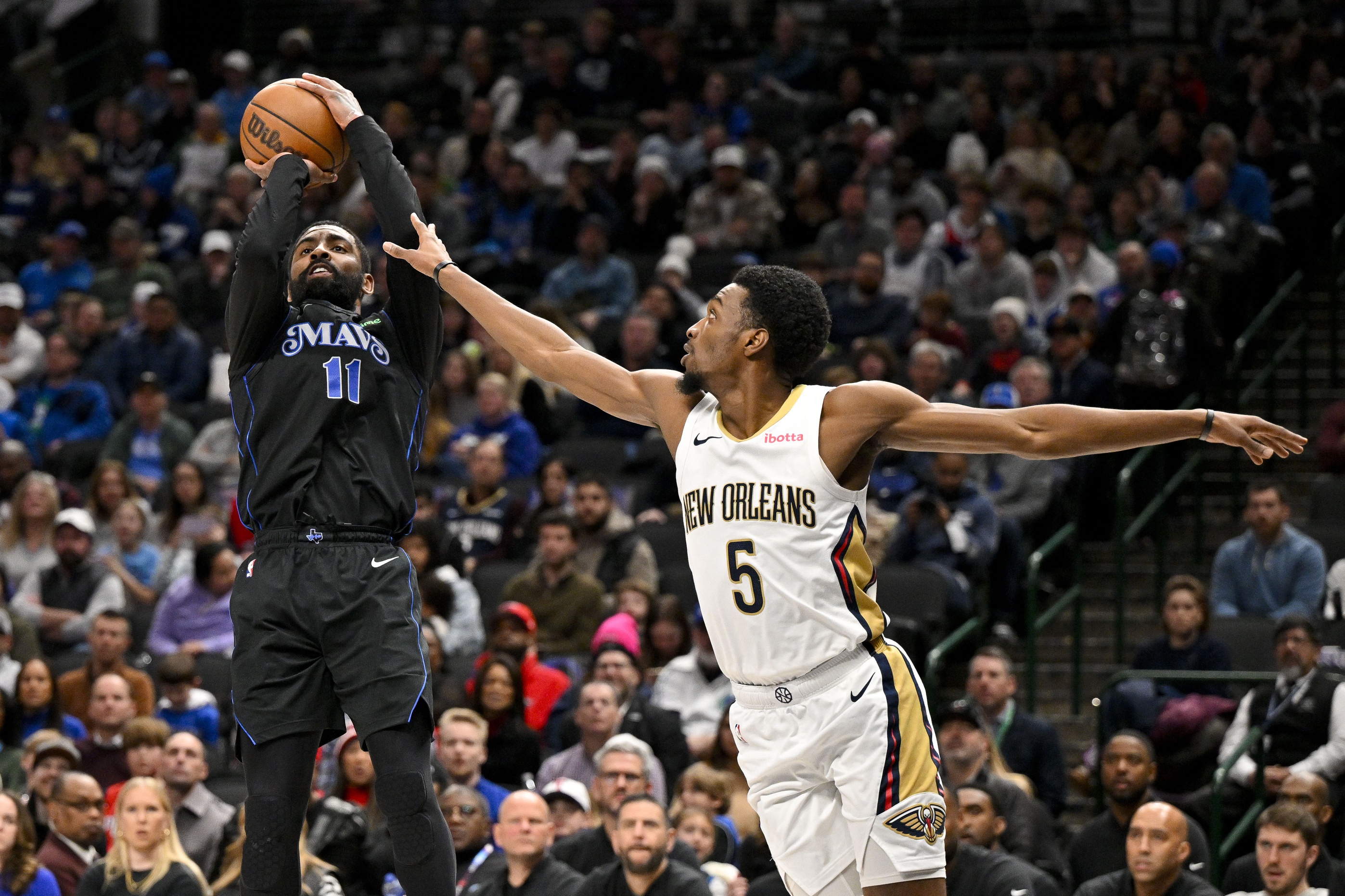 Dallas Mavericks guard Kyrie Irving (11) shoots the ball over New Orleans Pelicans forward Herbert Jones (5) during the second quarter at the American Airlines Center. Mandatory Credit: Jerome Miron-Imagn Images