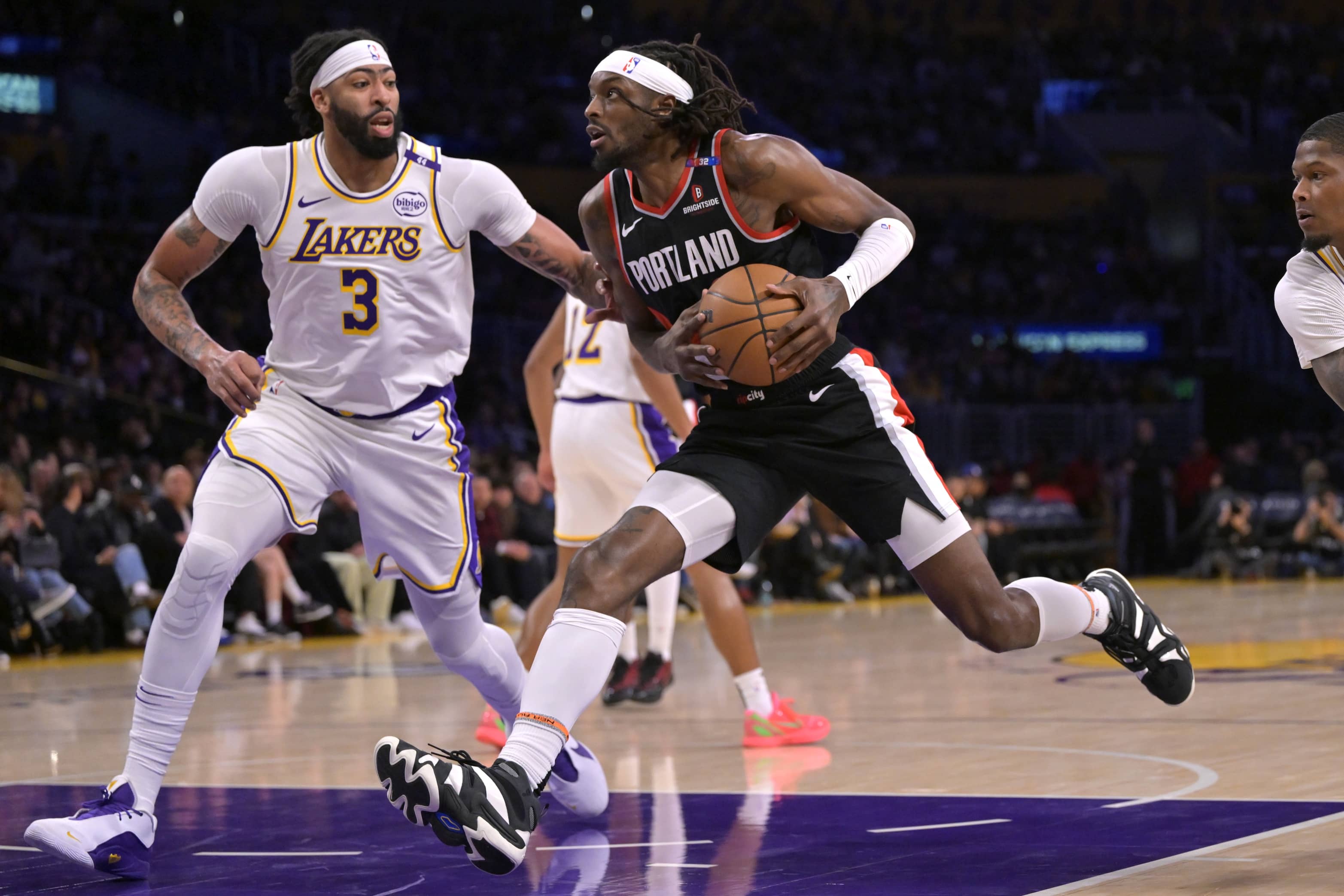 Dec 8, 2024; Los Angeles, California, USA; Portland Trail Blazers forward Jerami Grant (9) drives past Los Angeles Lakers forward Anthony Davis (3) in the first half at Crypto.com Arena. Mandatory Credit: Jayne Kamin-Oncea-Imagn Images  