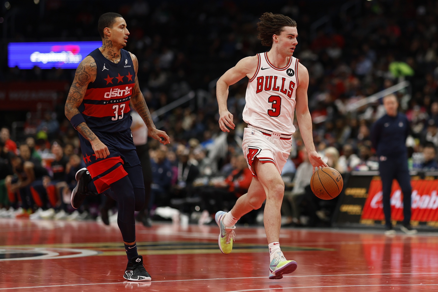 Nov 26, 2024; Washington, District of Columbia, USA; Chicago Bulls guard Josh Giddey (3) drives to the basket as Washington Wizards forward Kyle Kuzma (33) chases in the third quarter at Capital One Arena.