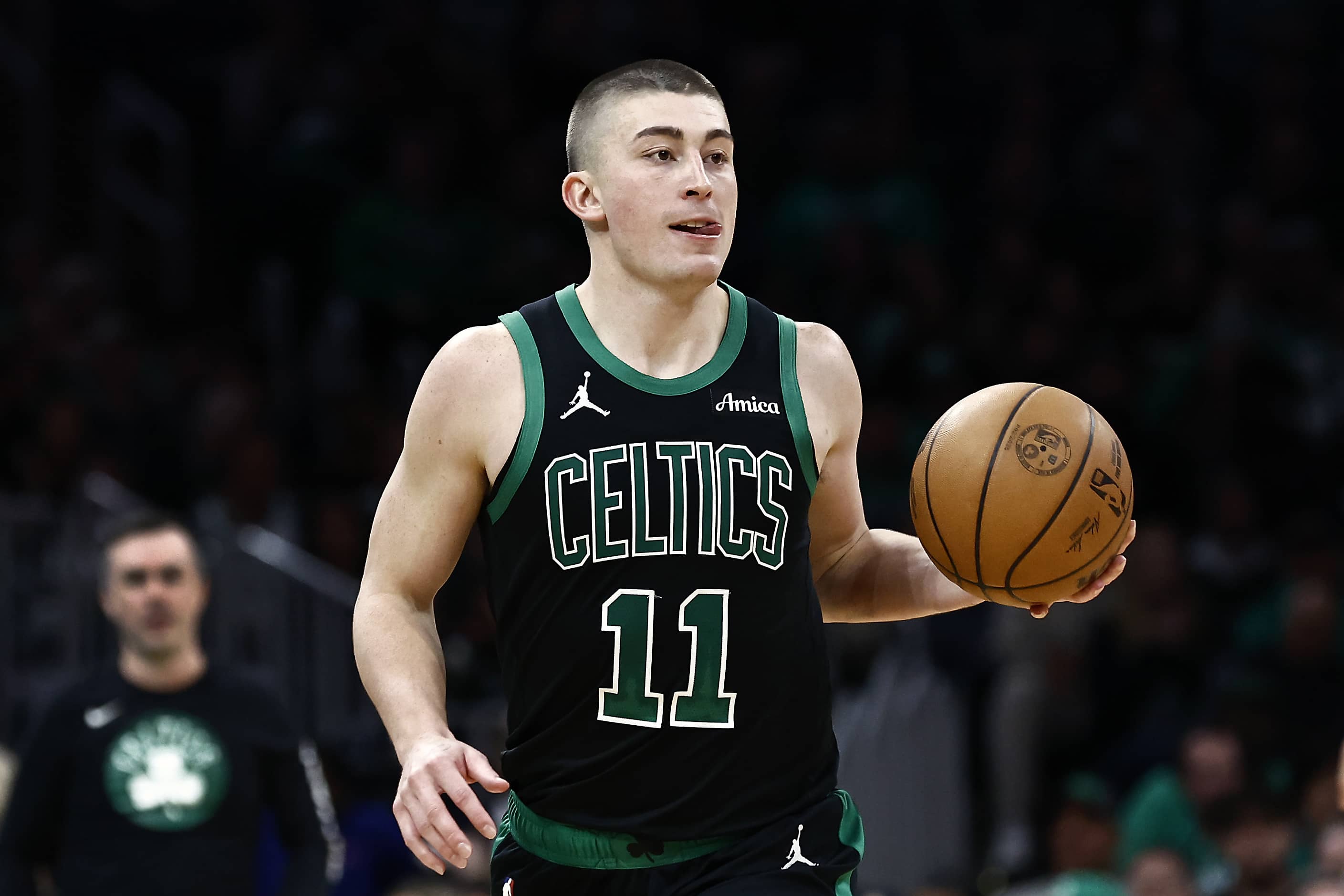 Boston, Massachusetts, USA; Boston Celtics guard Payton Pritchard (11) brings the ball up court against the Miami Heat during the second half at TD Garden. Mandatory Credit: Winslow Townson-Imagn Images