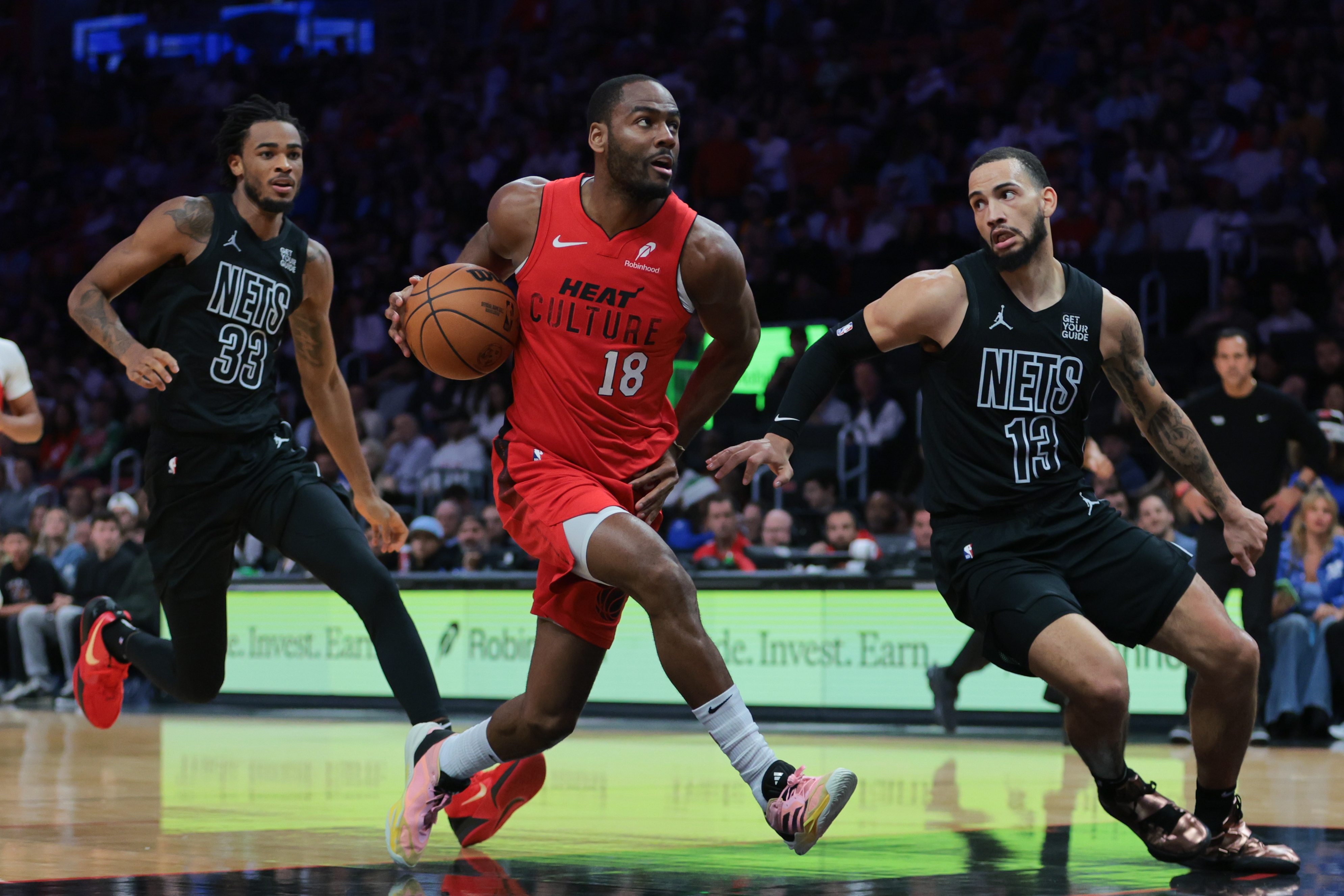 Dec 23, 2024; Miami, Florida, USA; Miami Heat guard Alec Burks (18) drives tot he basket against Brooklyn Nets guard Tyrese Martin (13) during the second quarter at Kaseya Center. Mandatory Credit: Sam Navarro-Imagn Images