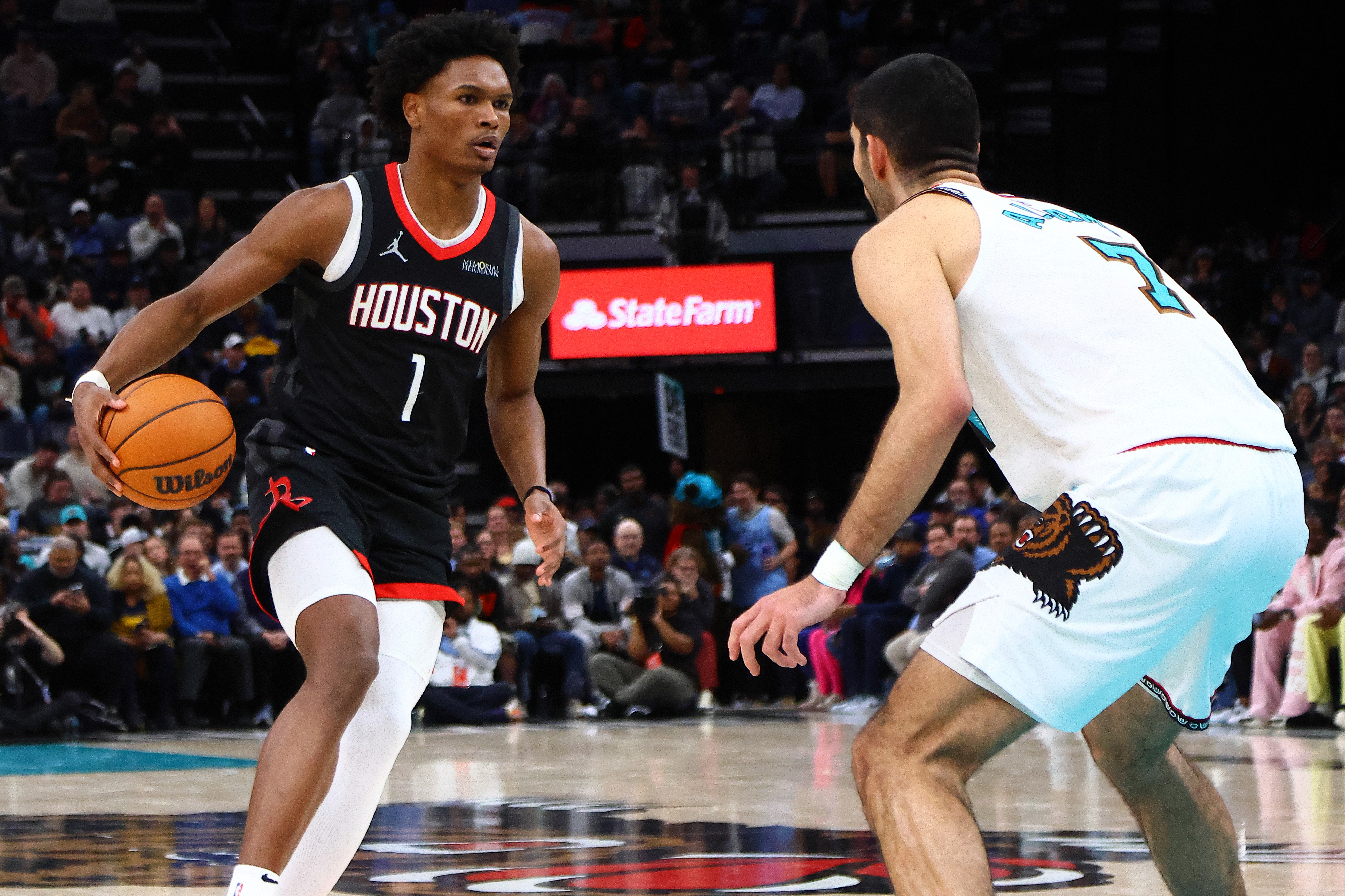 Jan 30, 2025; Memphis, Tennessee, USA; Houston Rockets forward Amen Thompson (1) dribbles as Memphis Grizzlies forward Santi Aldama (7) defends during the fourth quarter at FedExForum. Mandatory Credit: Petre Thomas-Imagn Images  