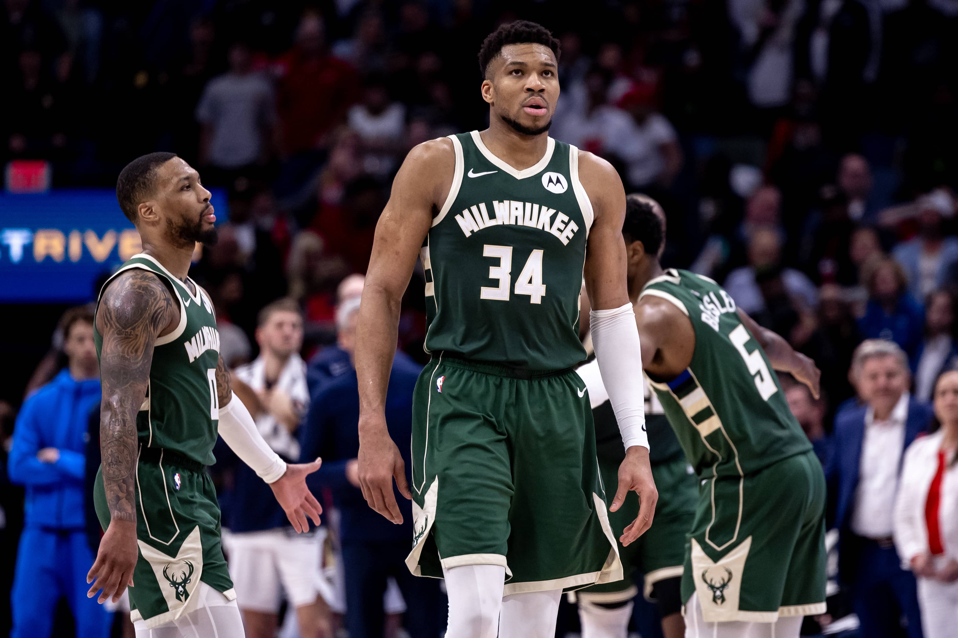 New Orleans, Louisiana, USA; Milwaukee Bucks forward Giannis Antetokounmpo (34) and guard Damian Lillard (0) head to the bench on a timer out against the New Orleans Pelicans during the second half at Smoothie King Center. Mandatory Credit: Stephen Lew-Imagn Images