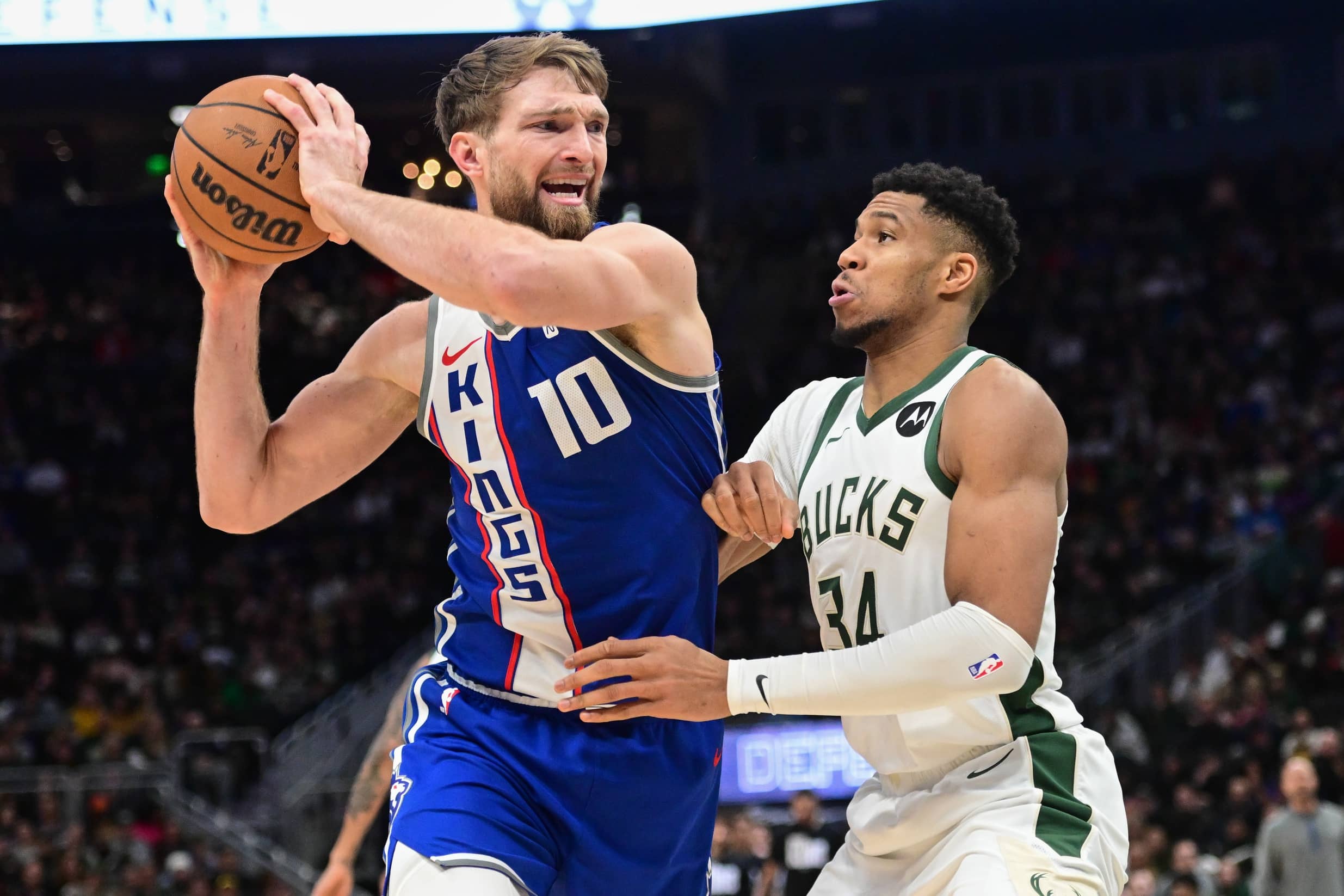 Sacramento Kings center Domantas Sabonis (10) drives for the basket against Milwaukee Bucks forward Giannis Antetokounmpo (34) in the fourth quarter at Fiserv Forum.
