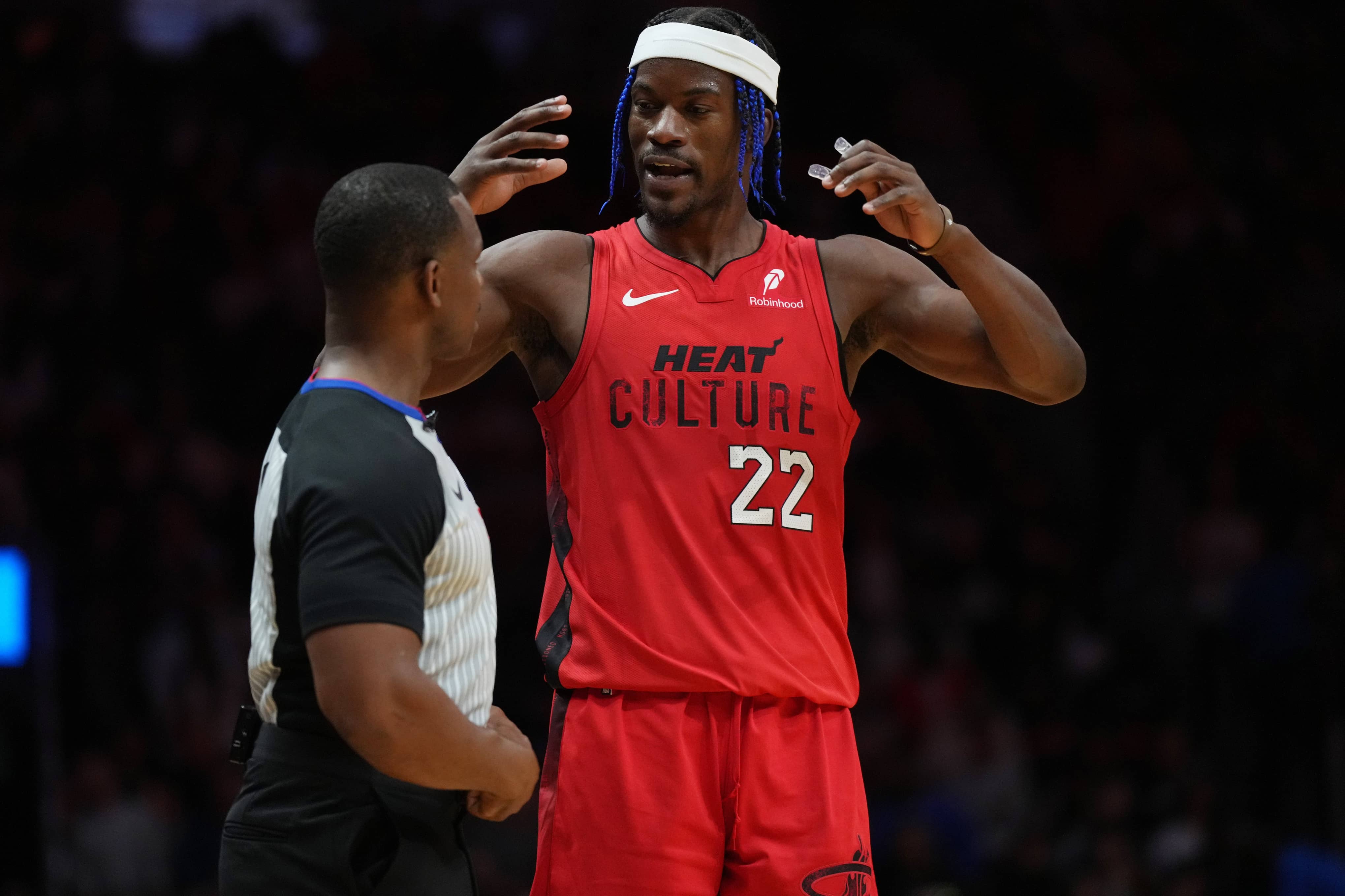 Dec 7, 2024; Miami, Florida, USA; Miami Heat forward Jimmy Butler (22) talks with official Dedric Taylor during a timeout in the second half against the Phoenix Suns at Kaseya Center. Mandatory Credit: Jim Rassol-Imagn Images