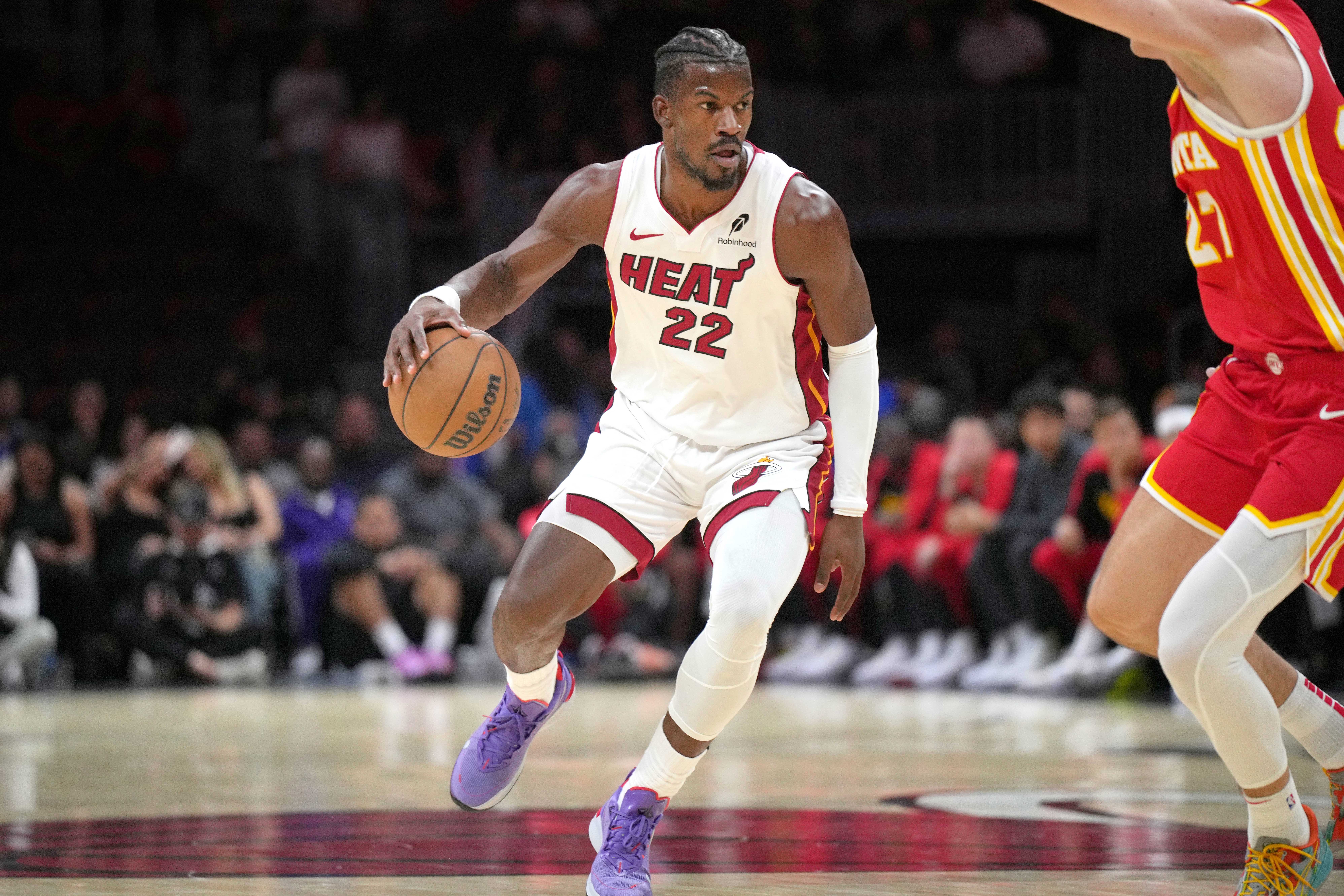 Miami, Florida, USA; Miami Heat forward Jimmy Butler (22) brings the ball up the court as Atlanta Hawks guard Vit Krejci (27) defends in the first half at Kaseya Center. Mandatory Credit: Jim Rassol-Imagn Images