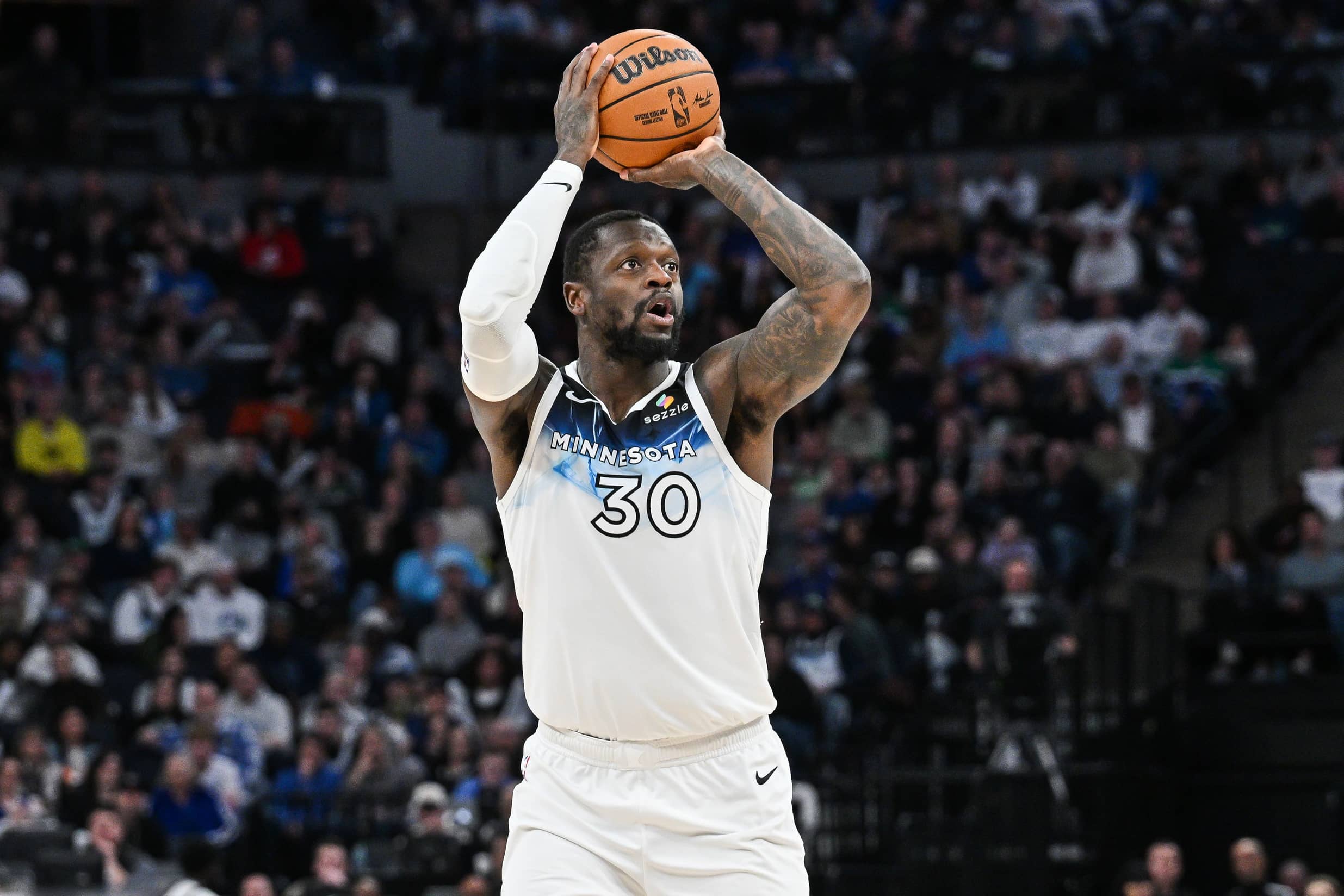 Minnesota Timberwolves forward Julius Randle (30) shoots a three point basket against the Denver Nuggets during the fourth quarter at Target Center.