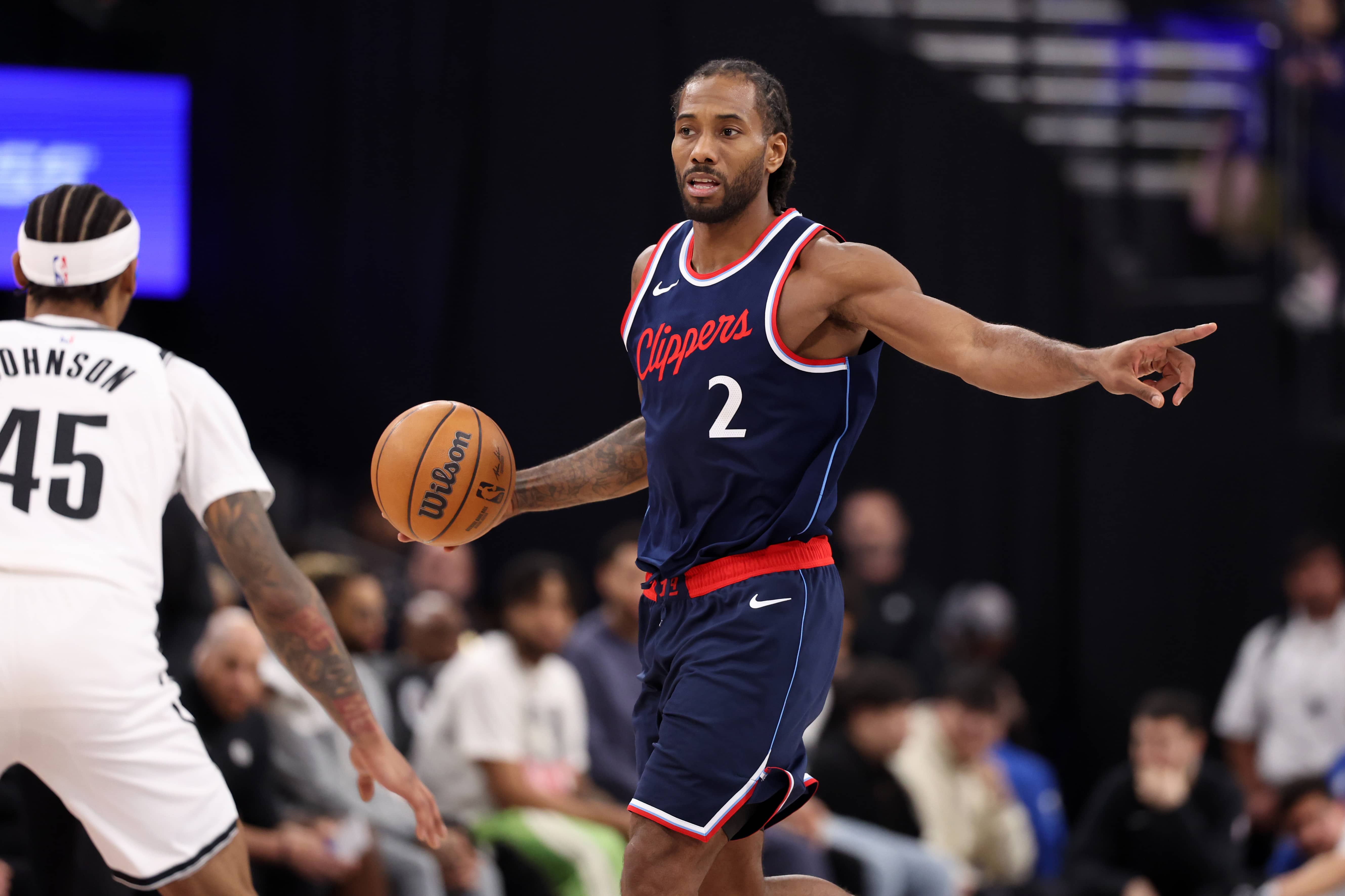 Inglewood, California, USA; LA Clippers forward Kawhi Leonard (2) dribbles against Brooklyn Nets guard Keon Johnson (45) during the first half at Intuit Dome. Mandatory Credit: Kiyoshi Mio-Imagn Images