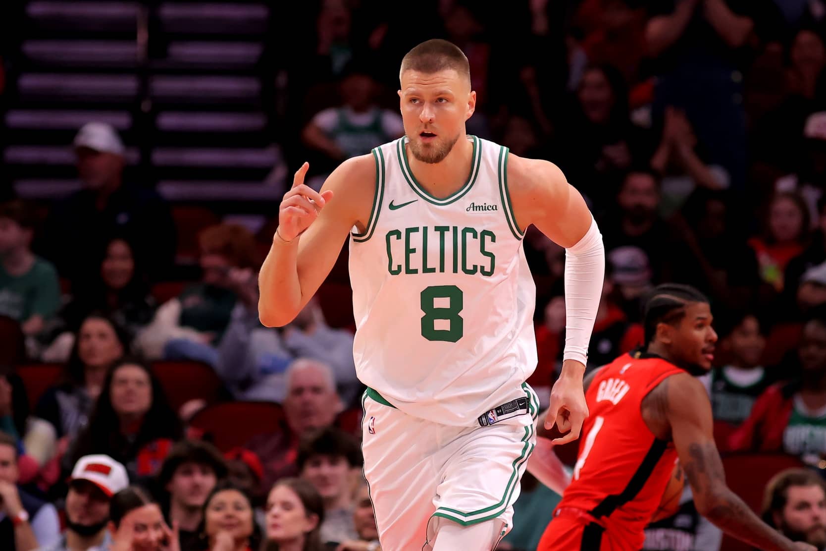 Boston Celtics center Kristaps Porzingis (8) reacts after a dunk against the Houston Rockets during the first quarter at Toyota Center.