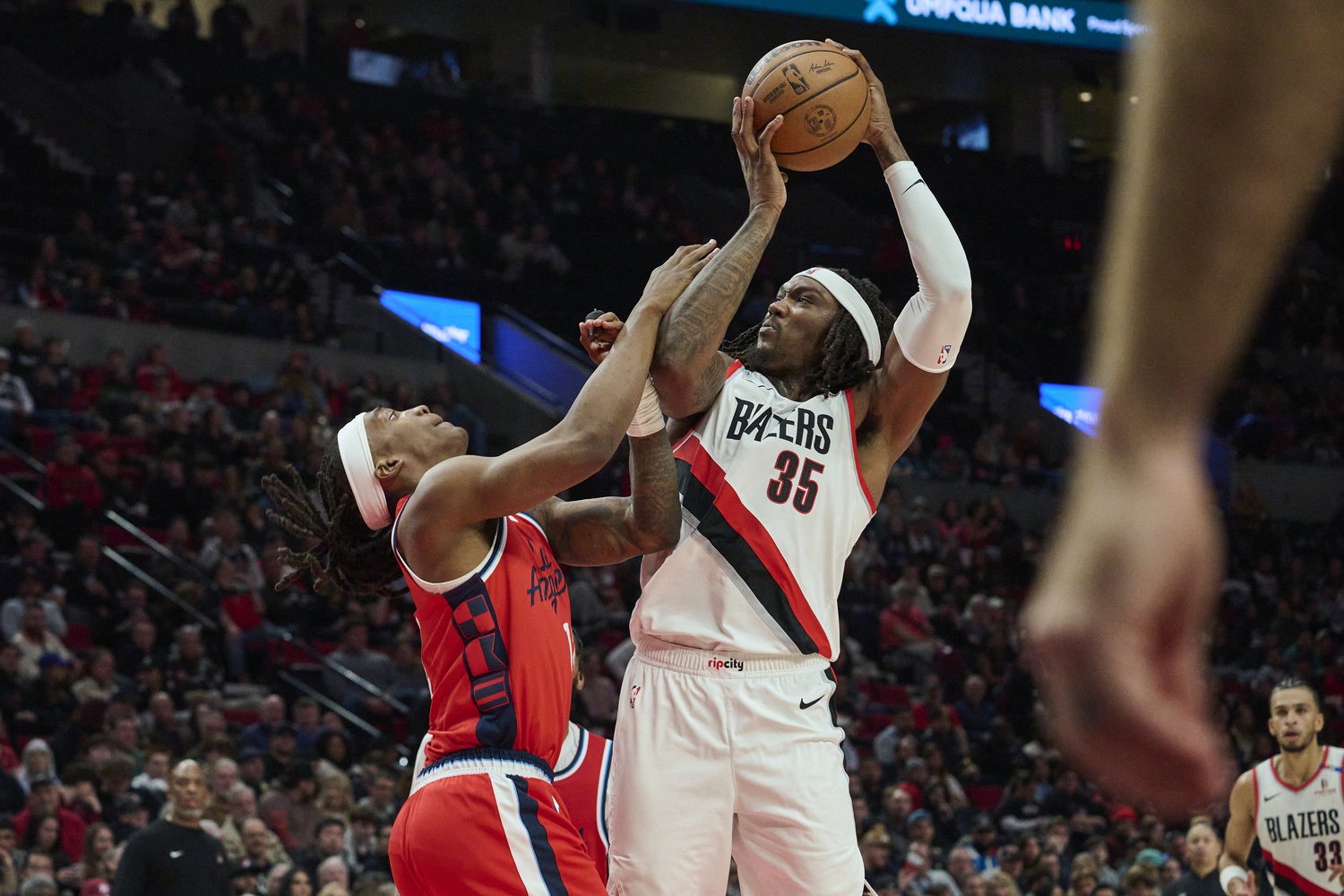Portland Trail Blazers center Robert Williams III (35) grabs a rebound during the second half against LA Clippers guard Terance Mann (14) at Moda Center. Mandatory Credit: Troy Wayrynen-Imagn Images