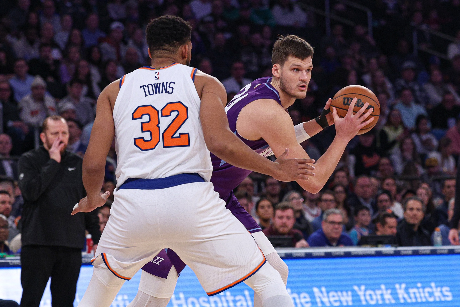 Utah Jazz center Walker Kessler (24) shields the ball from New York Knicks center Karl-Anthony Towns (32) during the first half at Madison Square Garden. Mandatory Credit: Vincent Carchietta-Imagn Images
