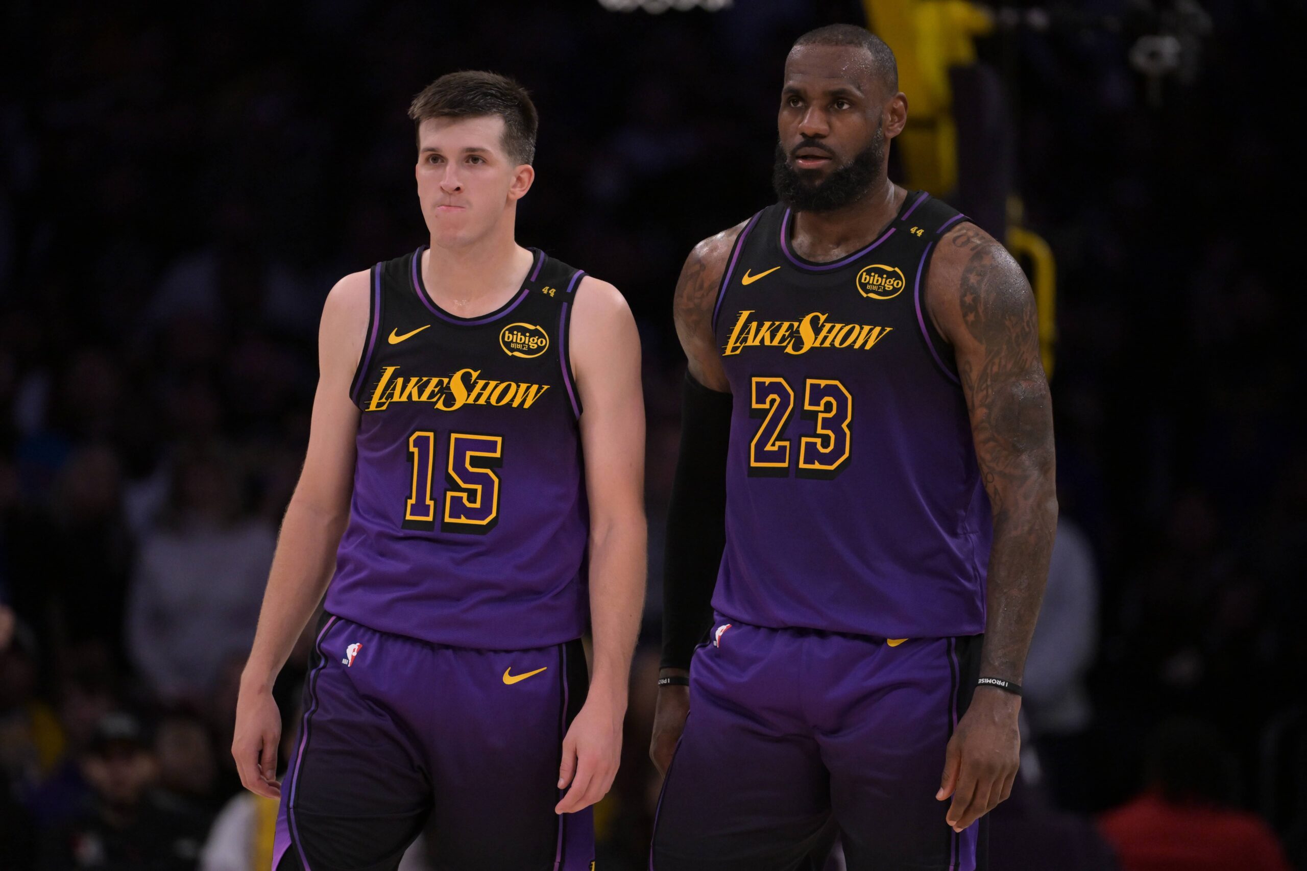 Los Angeles, California, USA; Los Angeles Lakers guard Austin Reaves (15) and forward LeBron James (23) talk on the court during a stoppage in play against the Orlando Magic at Crypto.com Arena. Mandatory Credit: Jayne Kamin-Oncea-Imagn Images