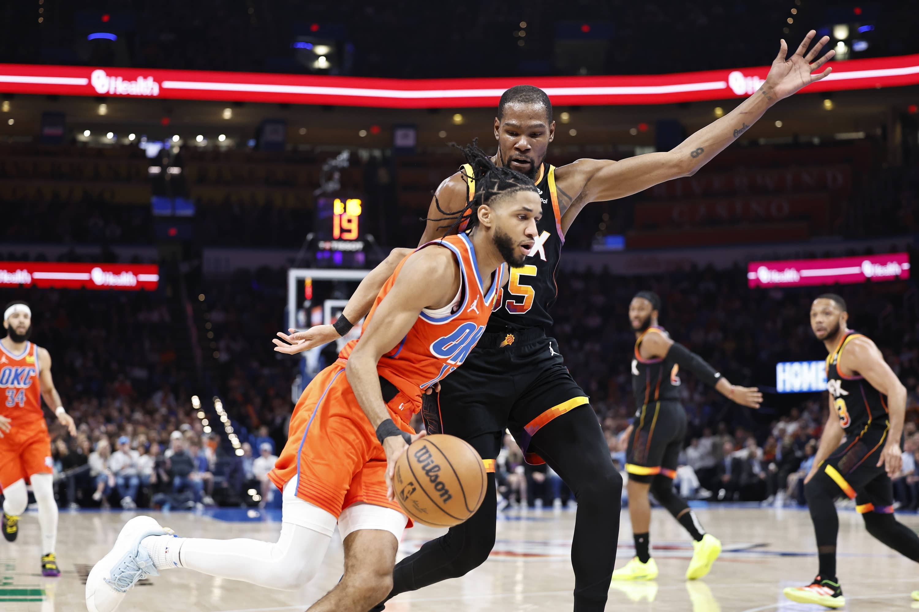 Mar 29, 2024; Oklahoma City, Oklahoma, USA; Oklahoma City Thunder guard Isaiah Joe (11) moves past Phoenix Suns forward Kevin Durant (35) during the second half at Paycom Center. Mandatory Credit: Alonzo Adams-Imagn Images