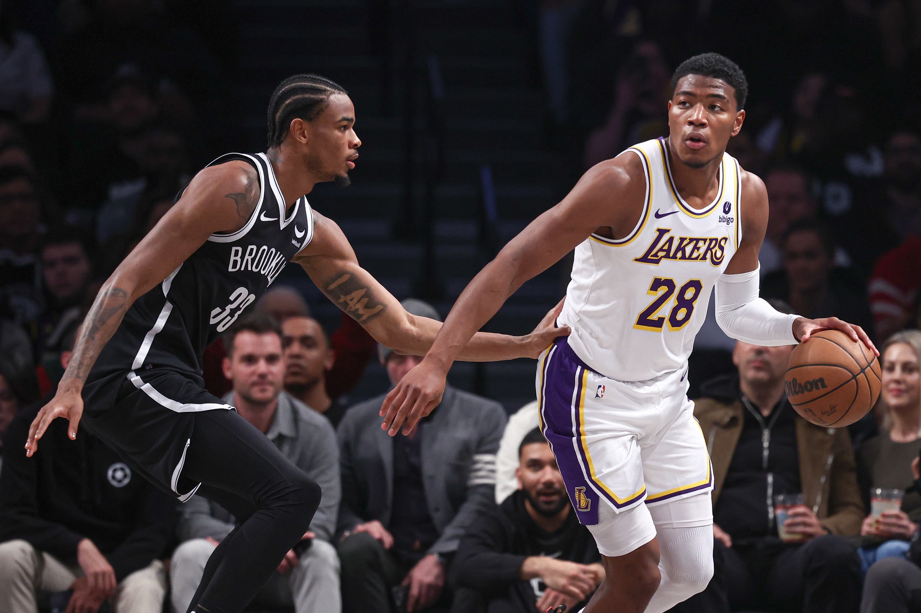 Los Angeles Lakers forward Rui Hachimura (28) dribbles against Brooklyn Nets center Nic Claxton (33) during the first half at Barclays Center. Mandatory Credit: Vincent Carchietta-Imagn Images
