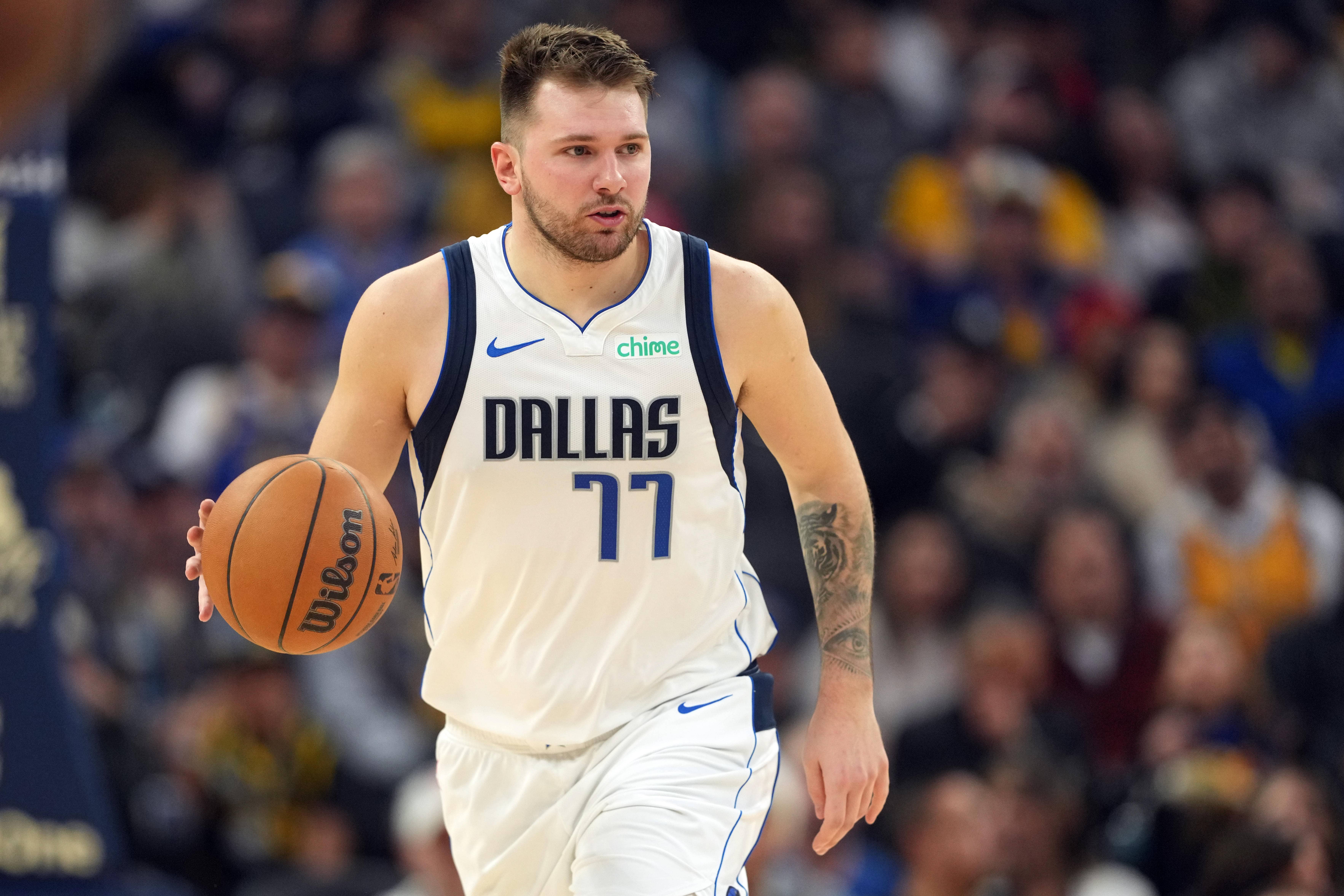 San Francisco, California, USA; Dallas Mavericks guard Luka Doncic (77) dribbles against the Golden State Warriors during the second quarter at Chase Center. Mandatory Credit: Darren Yamashita-Imagn Images