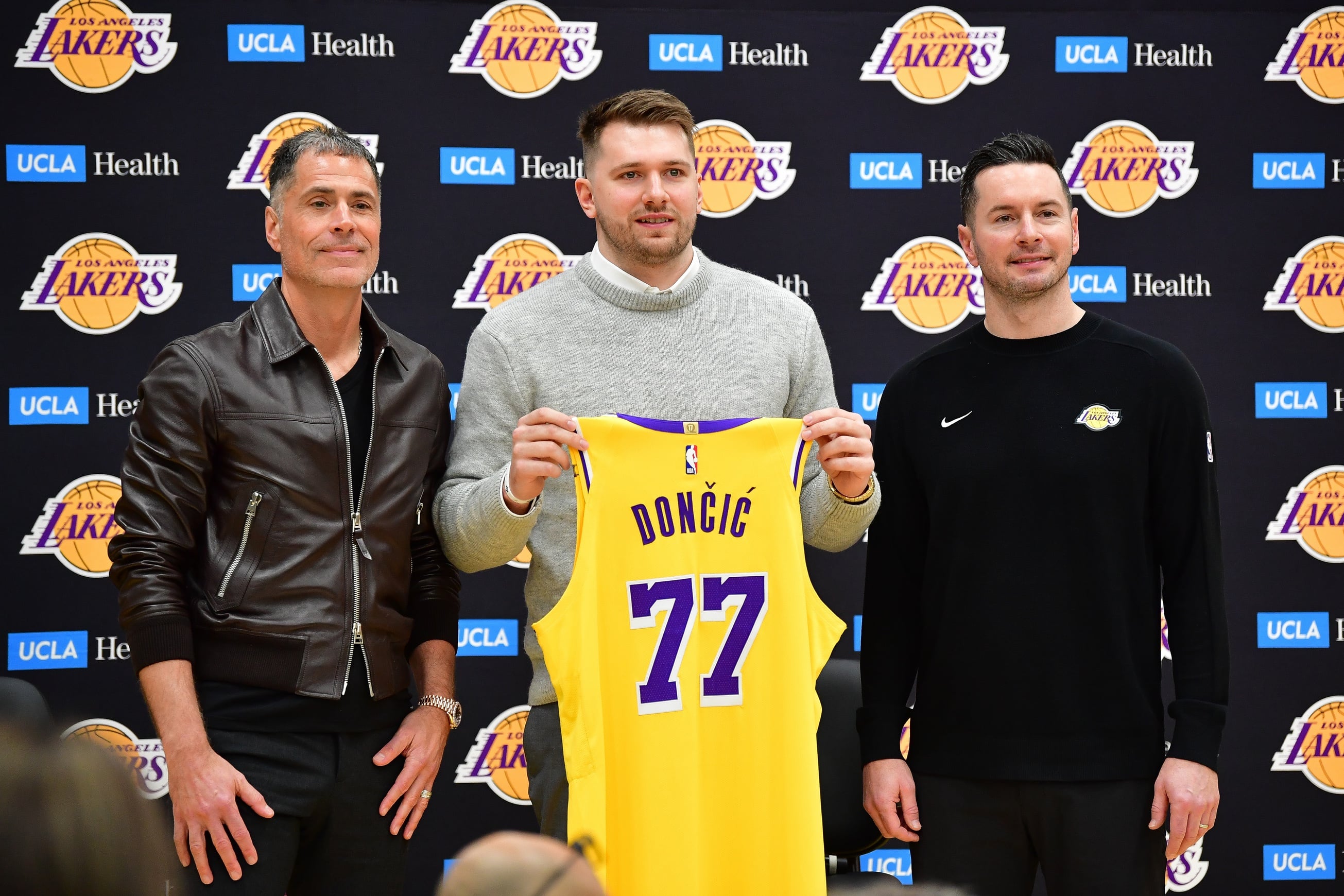 Feb 4, 2025; El Segundo, CA, USA; Los Angeles Lakers guard Luka Doncic poses for photos with general manager Rob Pelinka and head coach JJ Redick at UCLA Health Training Center. Mandatory Credit: Gary A. Vasquez-Imagn Images 