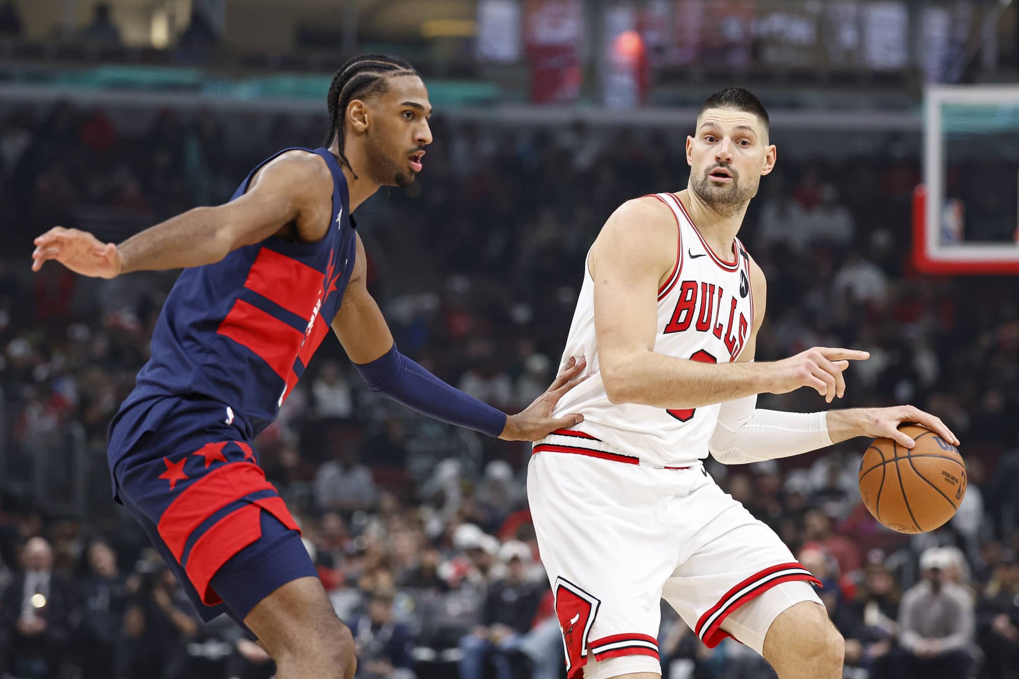 Chicago Bulls center Nikola Vucevic (9) drives to the basket against Washington Wizards forward Alexandre Sarr (20) during the first half at United Center. Mandatory Credit: Kamil Krzaczynski-Imagn Images