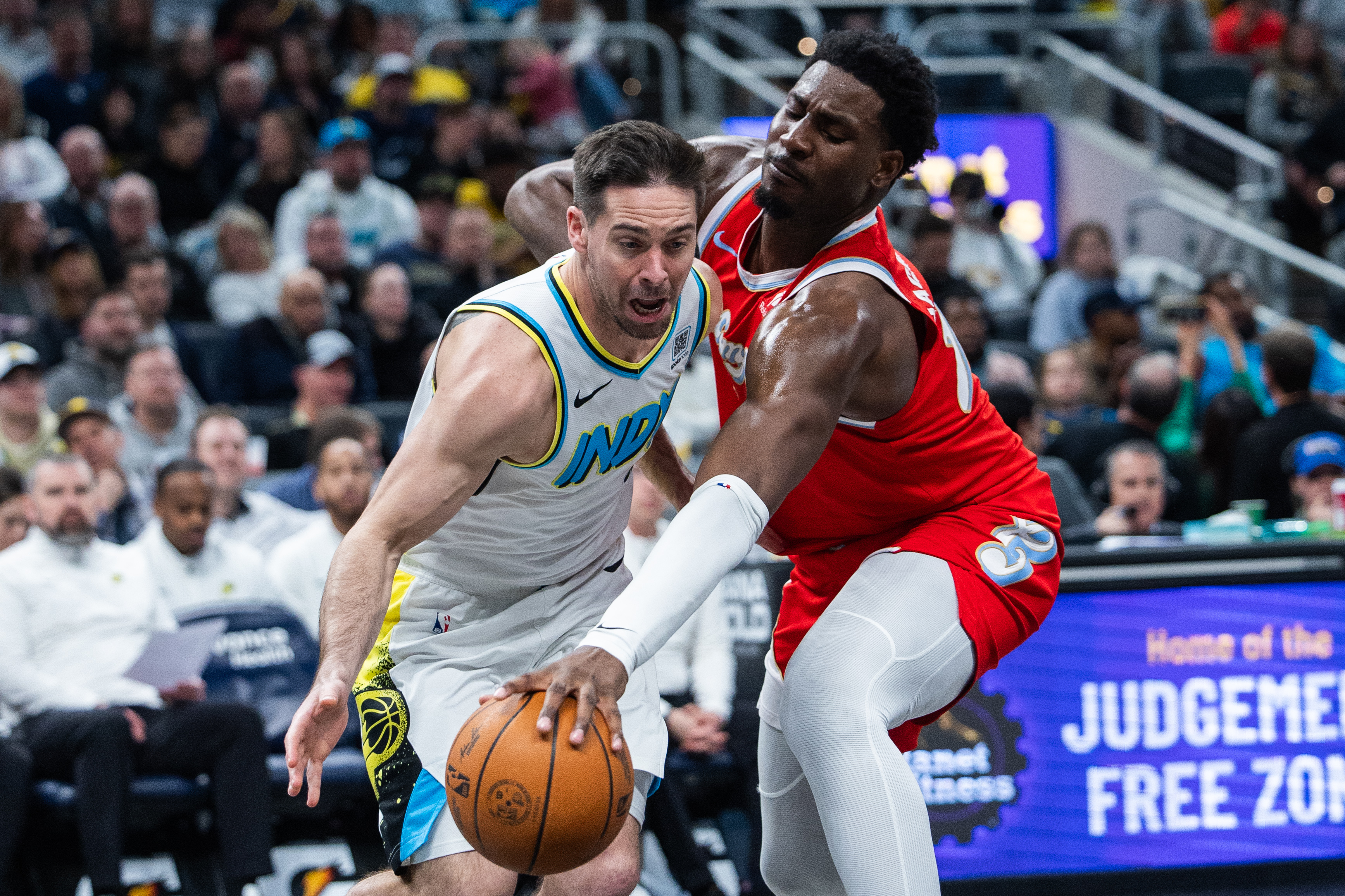 Feb 20, 2025; Indianapolis, Indiana, USA; Indiana Pacers guard T.J. McConnell (9) dribbles the ball while Memphis Grizzlies forward Jaren Jackson Jr. (13) defends in the second half at Gainbridge Fieldhouse. Mandatory Credit: Trevor Ruszkowski-Imagn Images  