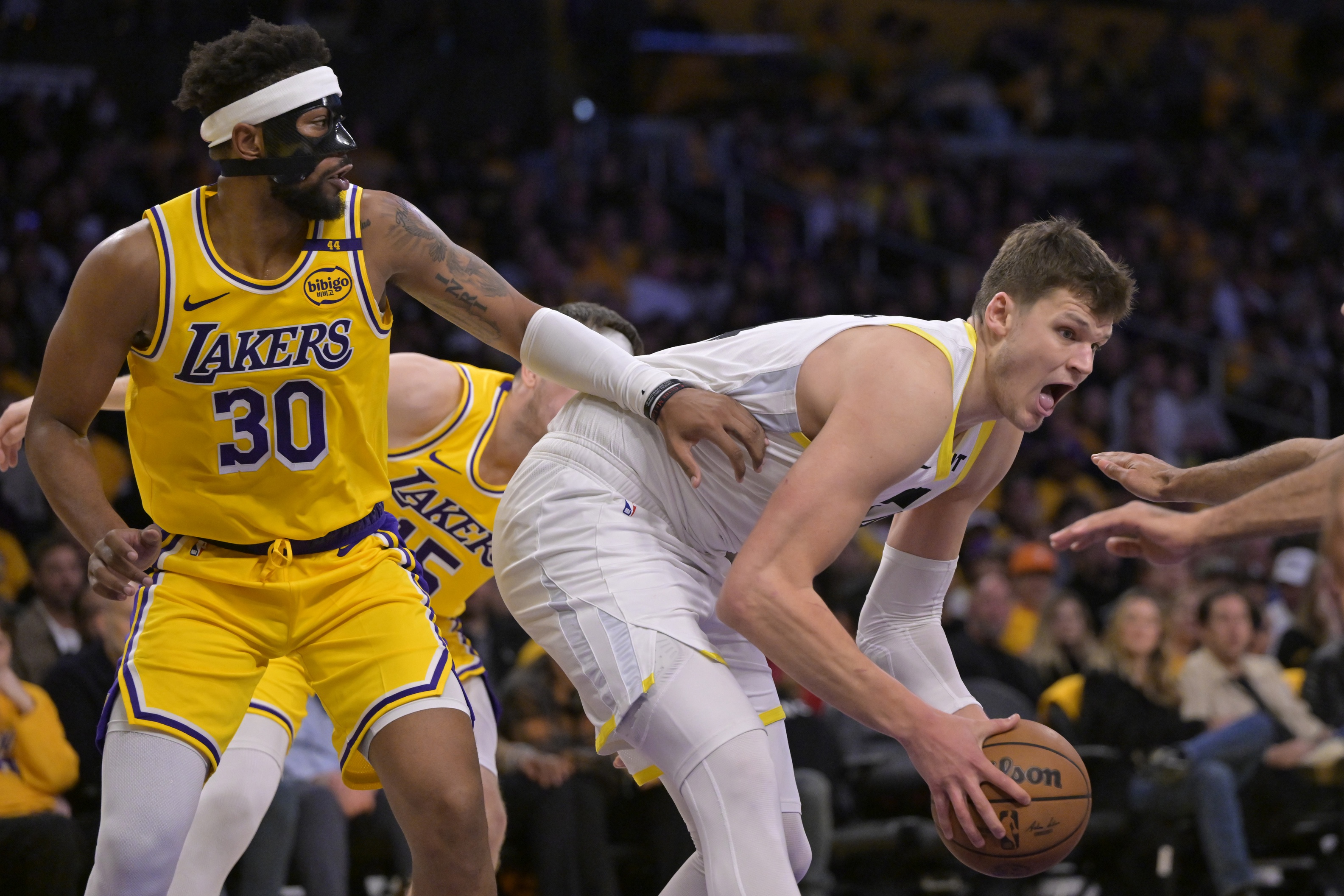 Utah Jazz center Walker Kessler (24) rebounds in front of Los Angeles Lakers guard Jordan Goodwin (30) in the second half at Crypto.com Arena. Mandatory Credit: Jayne Kamin-Oncea-Imagn Images