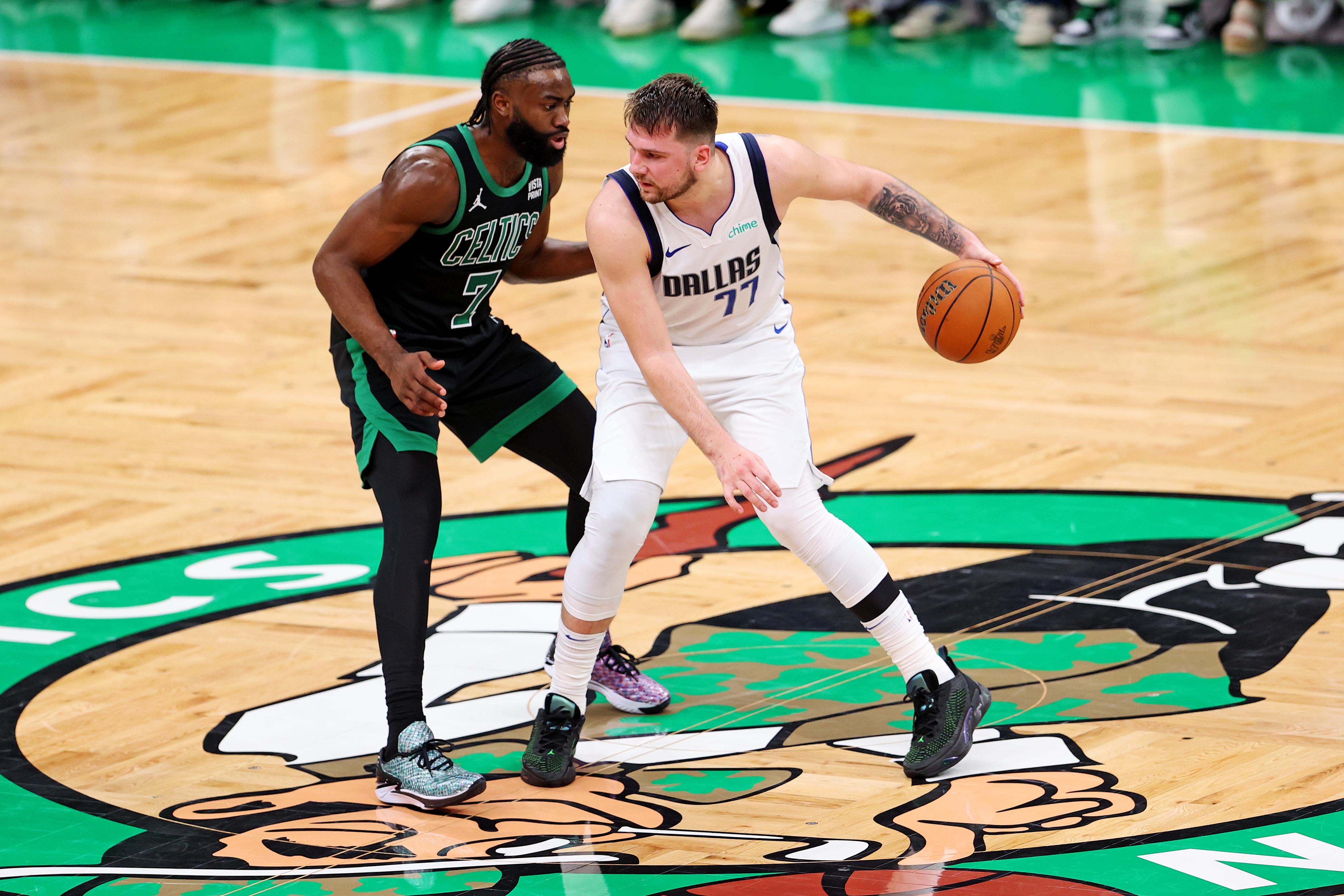 Jun 9, 2024; Boston, Massachusetts, USA; Dallas Mavericks guard Luka Doncic (77) handles the ball against Boston Celtics guard Jaylen Brown (7) during game two of the 2024 NBA Finals at TD Garden. Mandatory Credit: Peter Casey-Imagn Images  