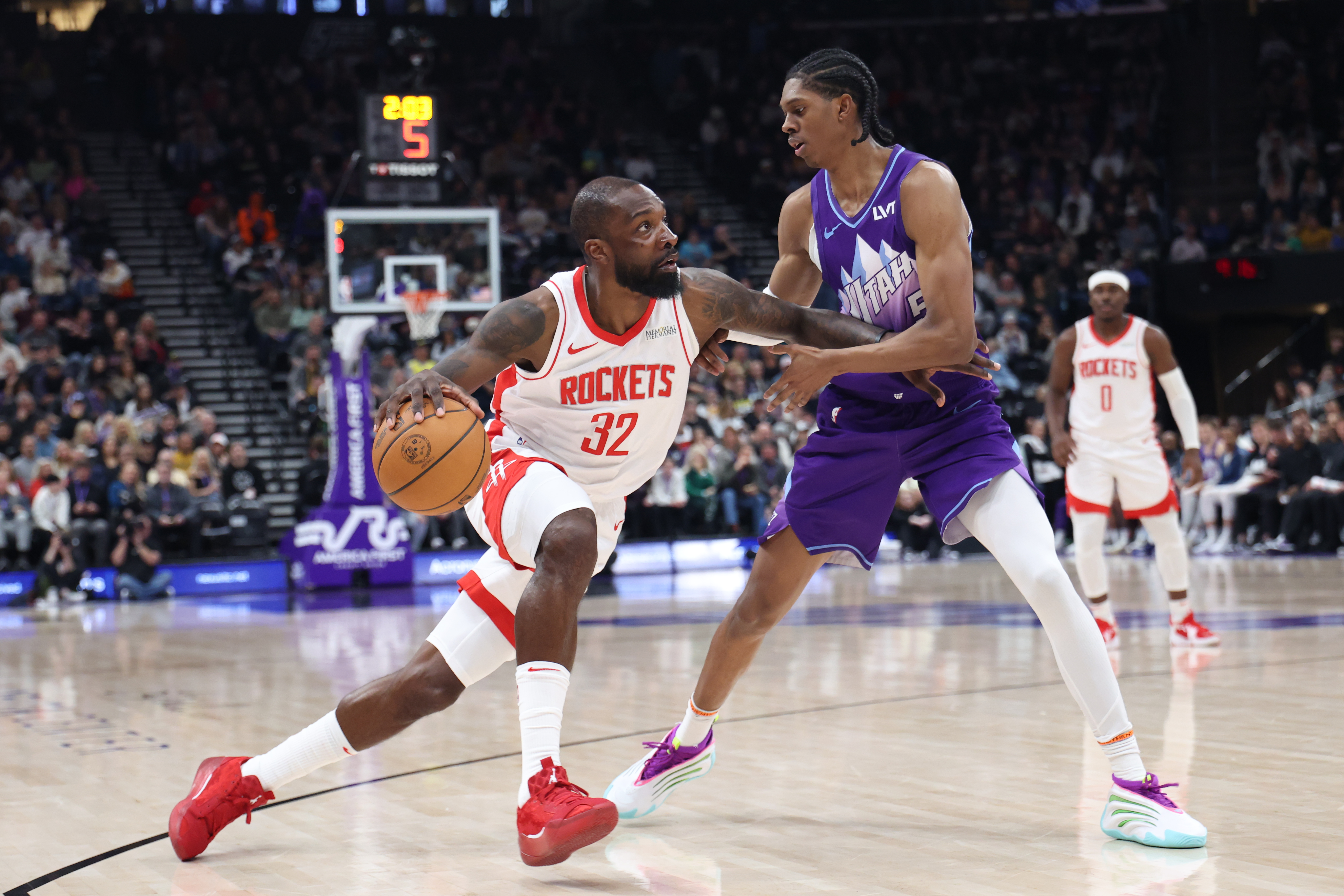 Feb 22, 2025; Salt Lake City, Utah, USA;Houston Rockets forward Jeff Green (32) drives against Utah Jazz forward Cody Williams (5) during the second half at Delta Center. Mandatory Credit: Rob Gray-Imagn Images  