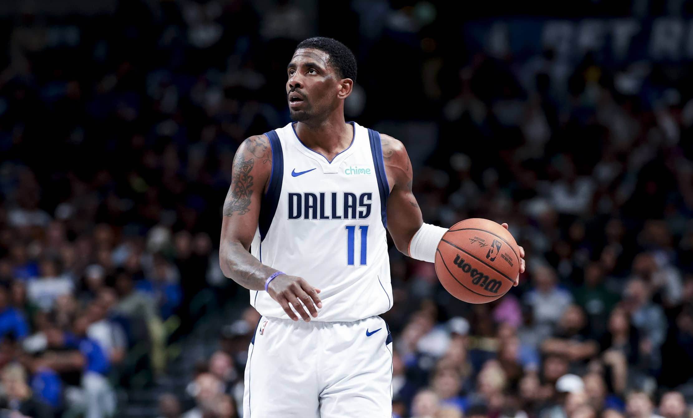 Dallas Mavericks guard Kyrie Irving (11) controls the ball against the Charlotte Hornets during the second half at American Airlines Center.