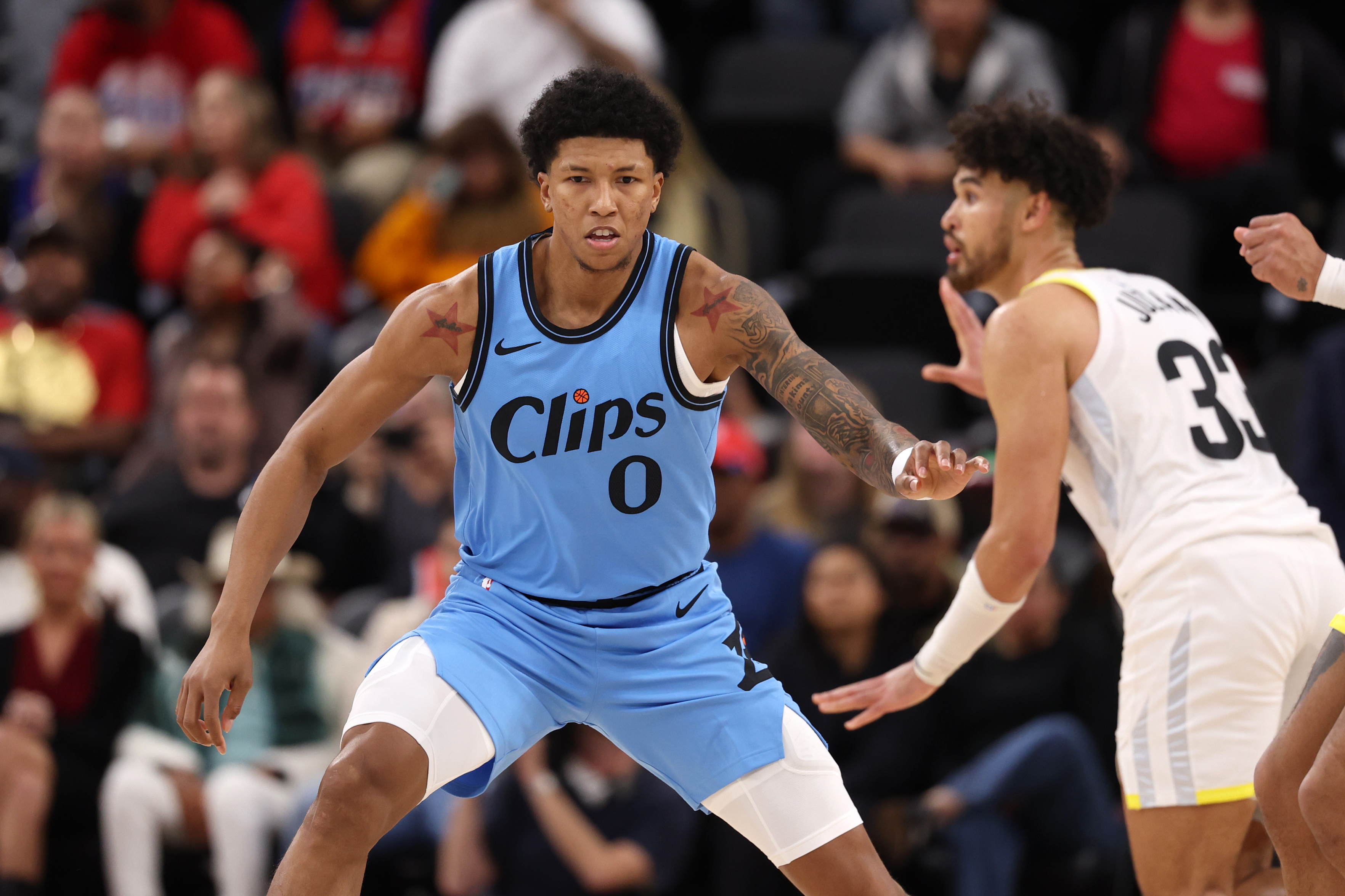 Feb 8, 2025; Inglewood, California, USA; Los Angeles Clippers forward MarJon Beauchamp (0) defends Utah Jazz guard Johnny Juzang (33) during the fourth quarter at Intuit Dome. Mandatory Credit: Kiyoshi Mio-Imagn Images  