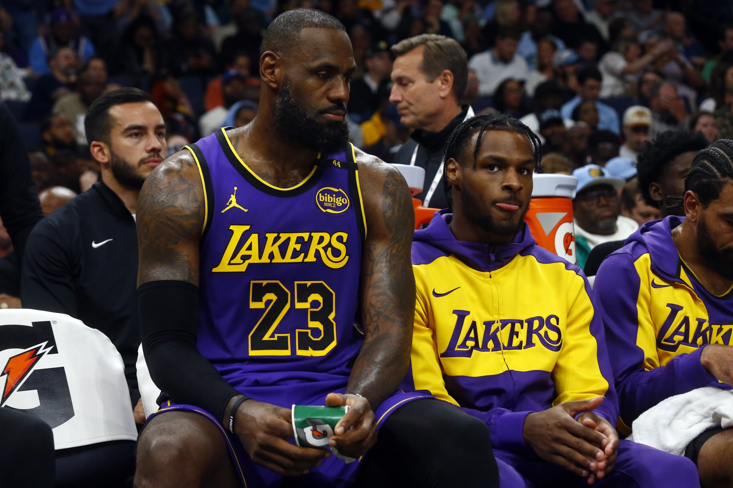 Memphis, Tennessee, USA; Los Angeles Lakers forward LeBron James (23) and Los Angeles Lakers guard Bronny James (9) sit on the bench during the first half against the Memphis Grizzlies at FedExForum. Mandatory Credit: Petre Thomas-Imagn Images