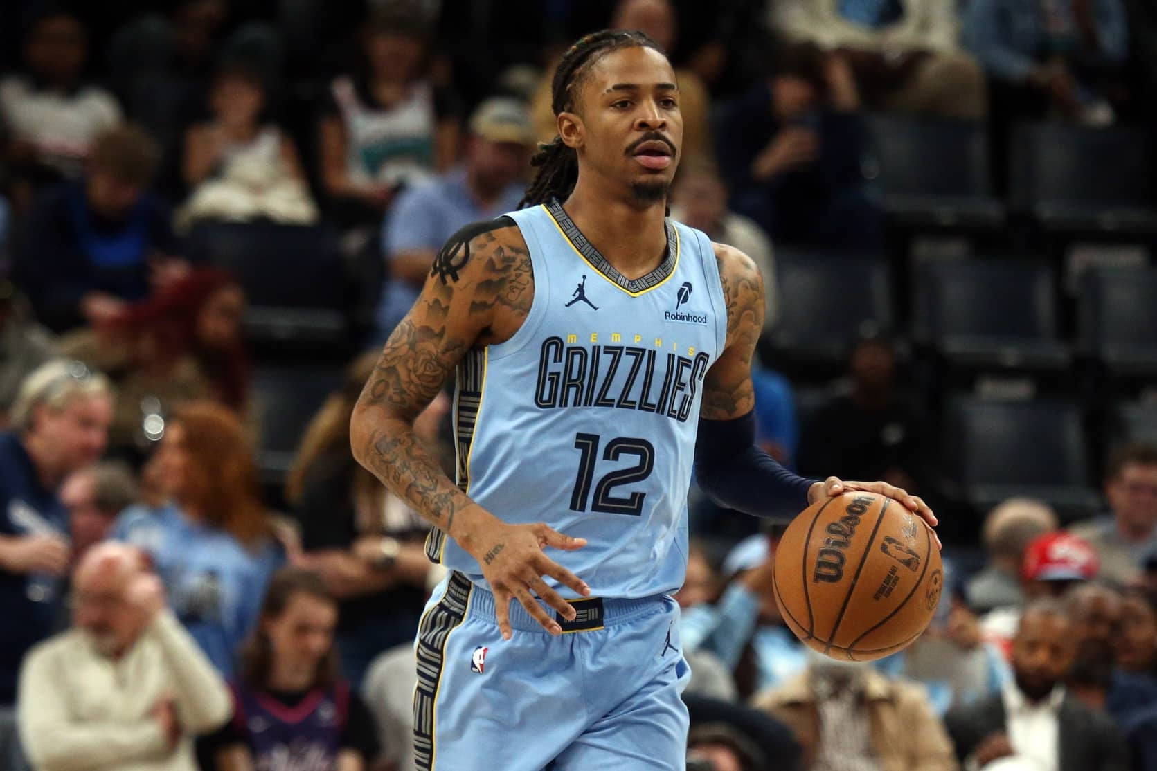 Memphis Grizzlies guard Ja Morant (12) dribbles up the court during the first quarter against the Phoenix Suns at FedExForum.