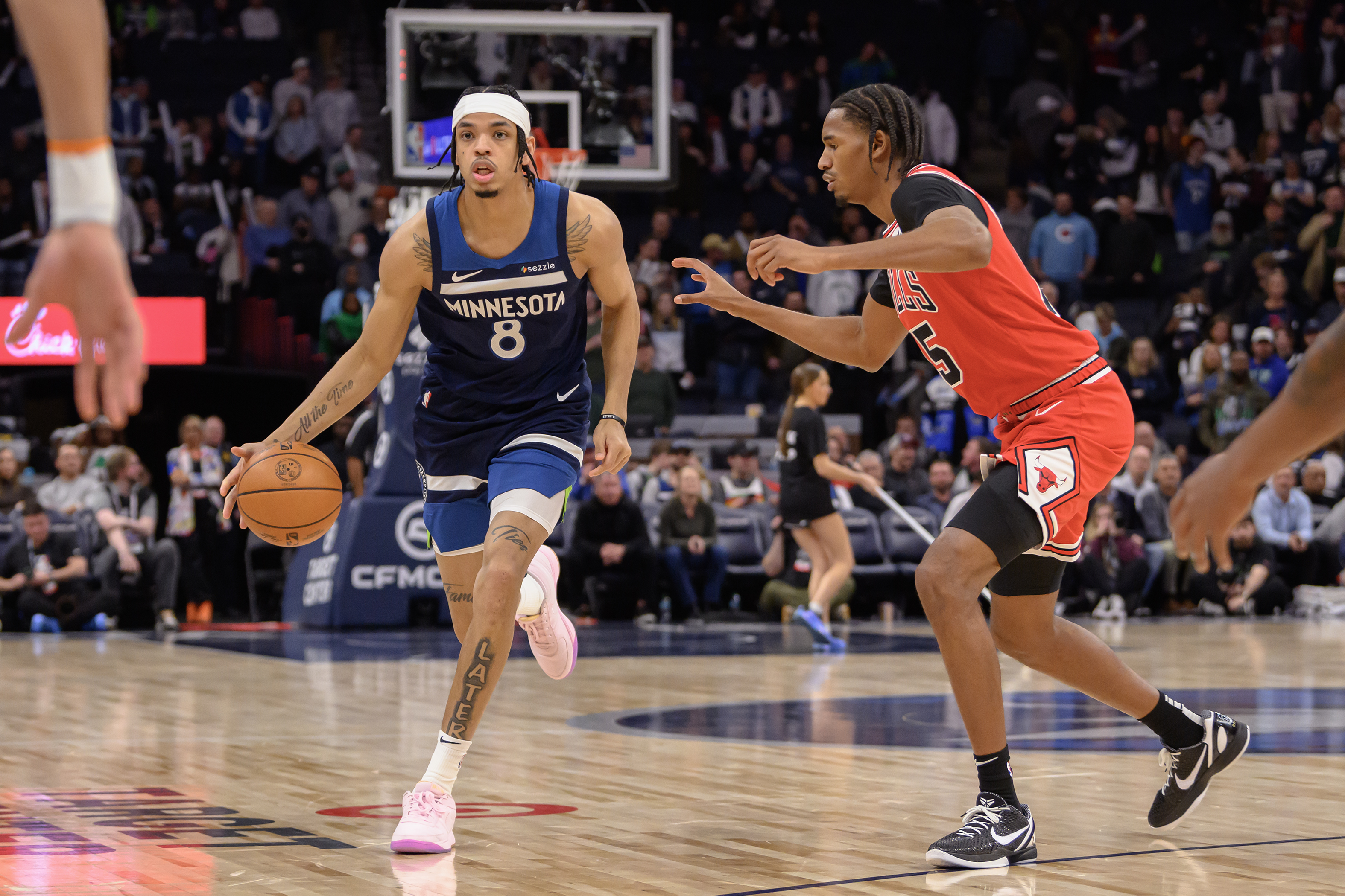 Feb 5, 2025; Minneapolis, Minnesota, USA; Minnesota Timberwolves forward Josh Minott (8) controls the ball as Chicago Bulls forward Julian Phillips (15) defends during the fourth quarter at Target Center. Mandatory Credit: Nick Wosika-Imagn Images  