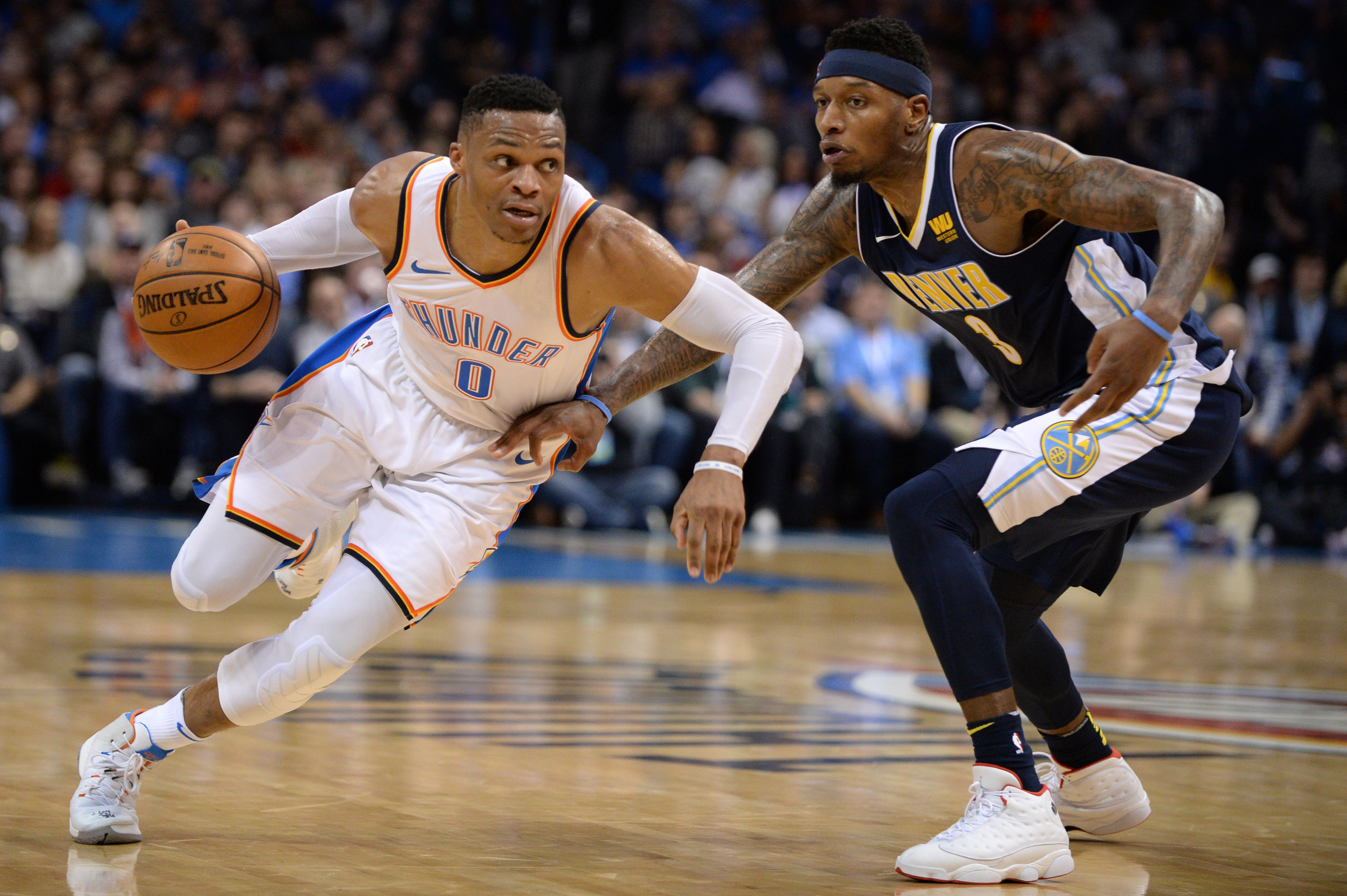 Dec 18, 2017; Oklahoma City, OK, USA; Oklahoma City Thunder guard Russell Westbrook (0) drives to the basket in front of Denver Nuggets guard Torrey Craig (3) during the fourth quarter at Chesapeake Energy Arena. Mandatory Credit: Mark D. Smith-Imagn Images  