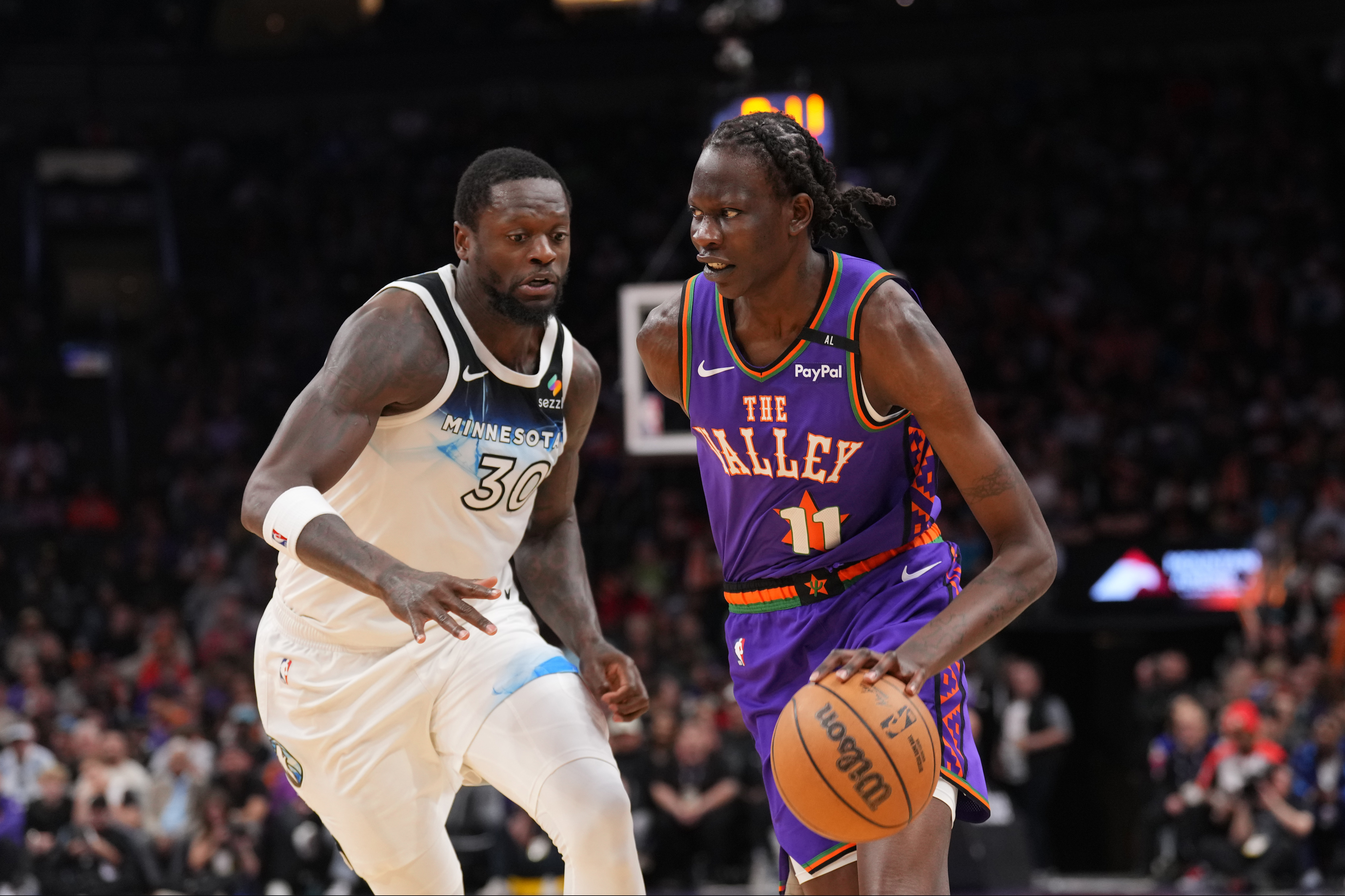 Mar 2, 2025; Phoenix, Arizona, USA; Phoenix Suns center Bol Bol (11) dribbles against Minnesota Timberwolves forward Julius Randle (30) during the second half at Footprint Center. Mandatory Credit: Joe Camporeale-Imagn Images  