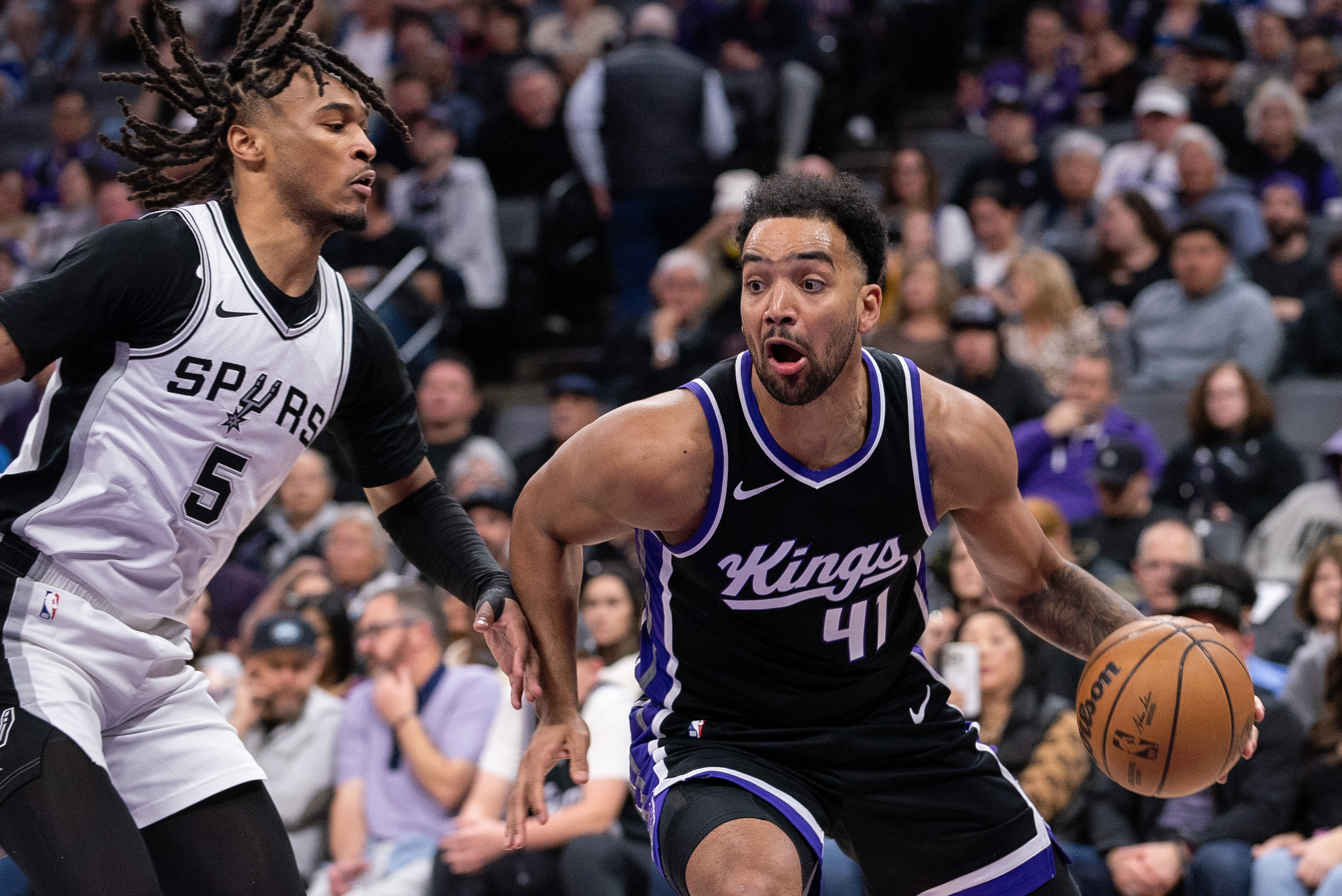 Mar 7, 2025; Sacramento, California, USA; Sacramento Kings forward Trey Lyles (41) drives to the basket against San Antonio Spurs guard Stephon Castle (5) during the first quarter at Golden 1 Center. Mandatory Credit: Ed Szczepanski-Imagn Images  