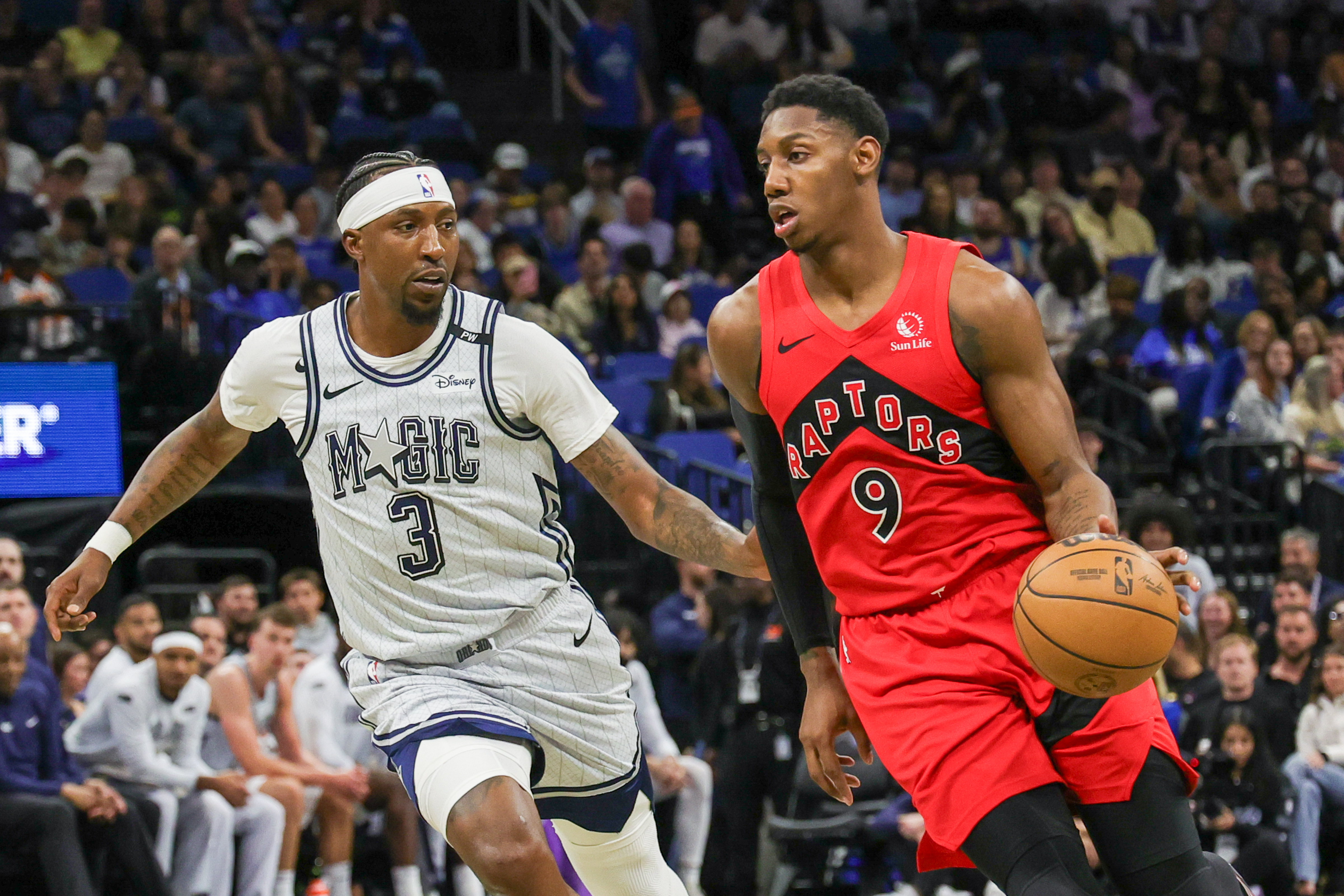Mar 2, 2025; Orlando, Florida, USA; Toronto Raptors guard RJ Barrett (9) drives around Orlando Magic guard Kentavious Caldwell-Pope (3) during the second half at Kia Center. Mandatory Credit: Mike Watters-Imagn Images  