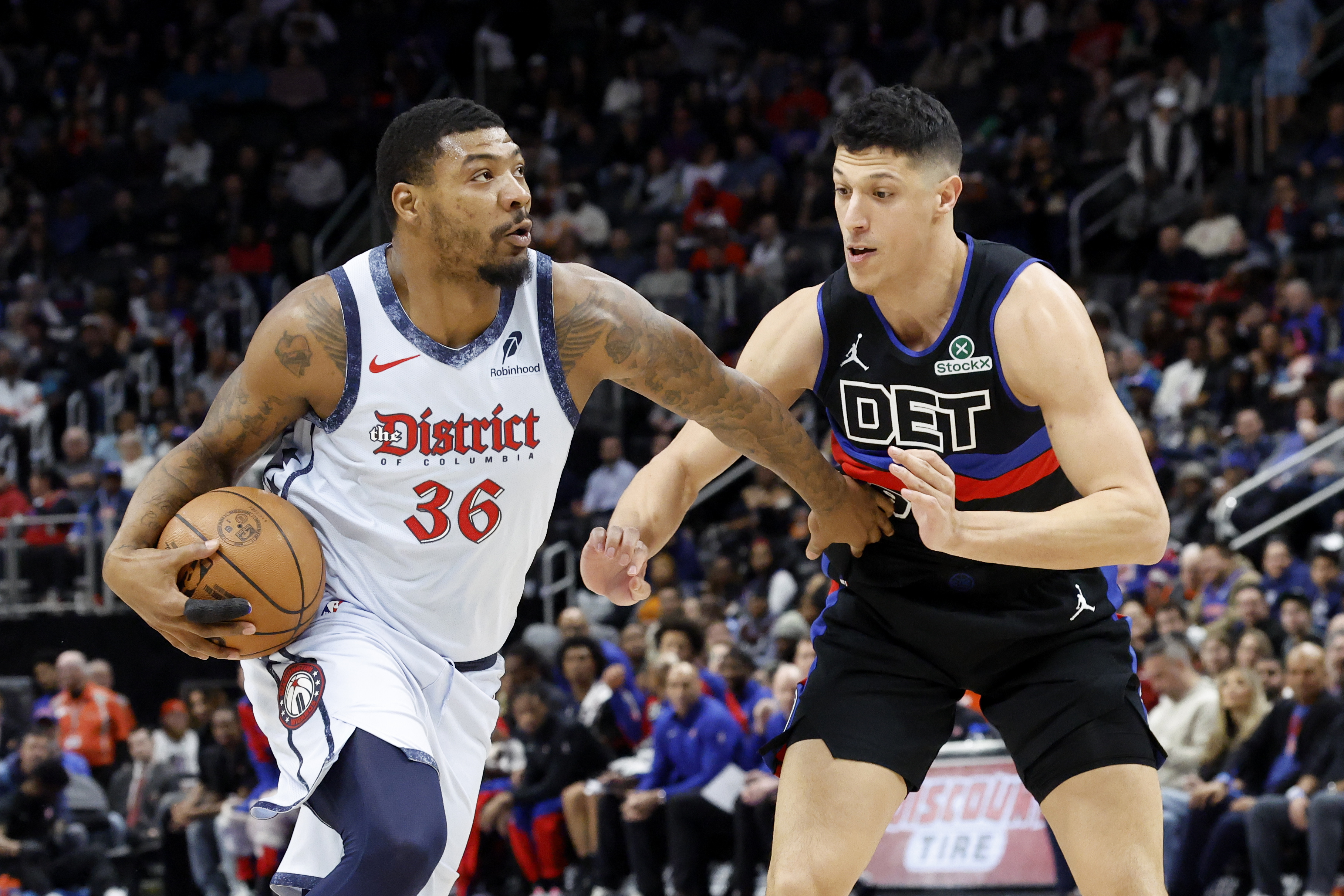Mar 13, 2025; Detroit, Michigan, USA; Washington Wizards guard Marcus Smart (36) dribbles defended by Detroit Pistons forward Simone Fontecchio (19) in the first half at Little Caesars Arena. Mandatory Credit: Rick Osentoski-Imagn Images  