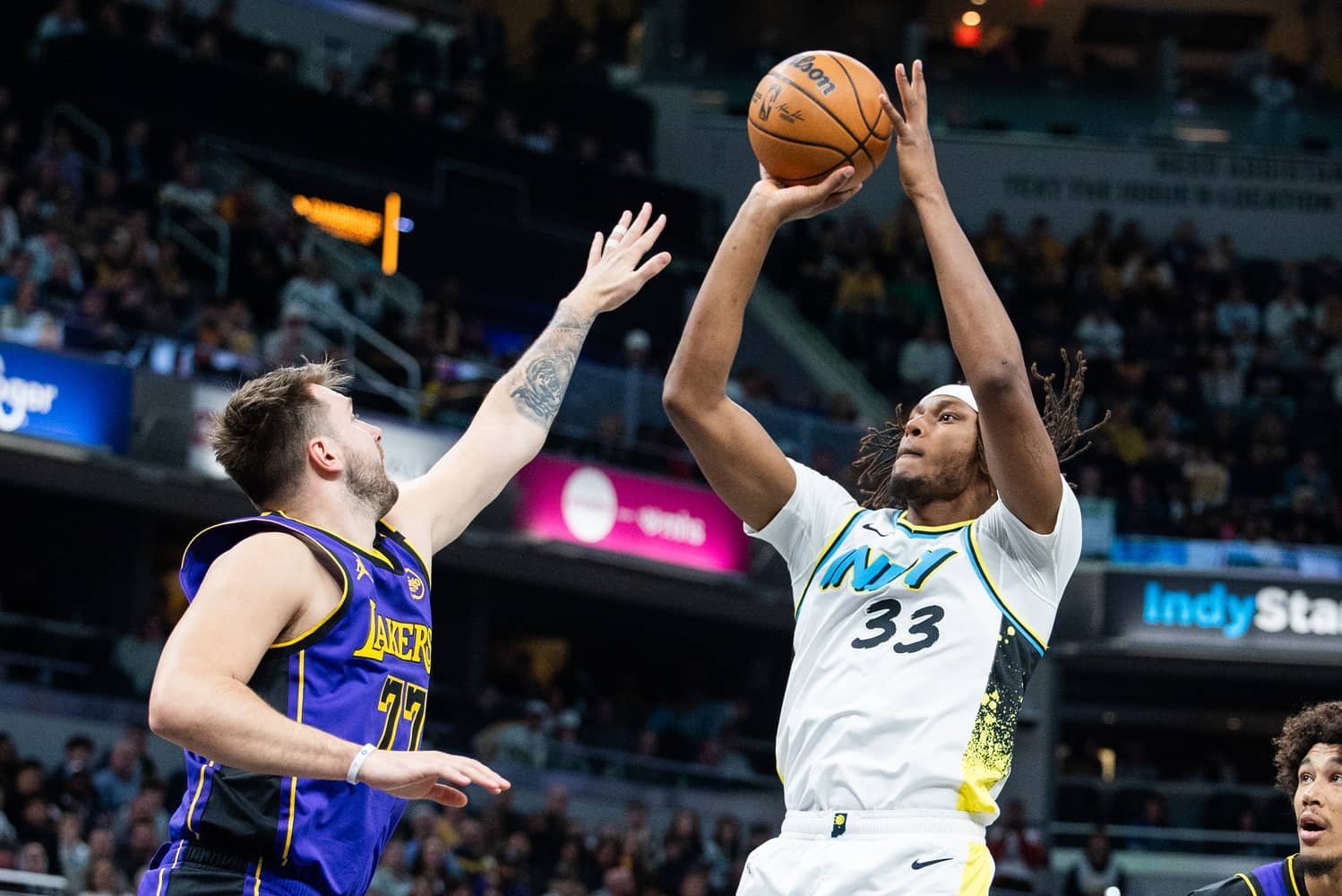 Mar 26, 2025; Indianapolis, Indiana, USA; Indiana Pacers center Myles Turner (33) shoots the ball while Los Angeles Lakers guard Luka Doncic (77) defends in the first half at Gainbridge Fieldhouse. Mandatory Credit: Trevor Ruszkowski-Imagn Images