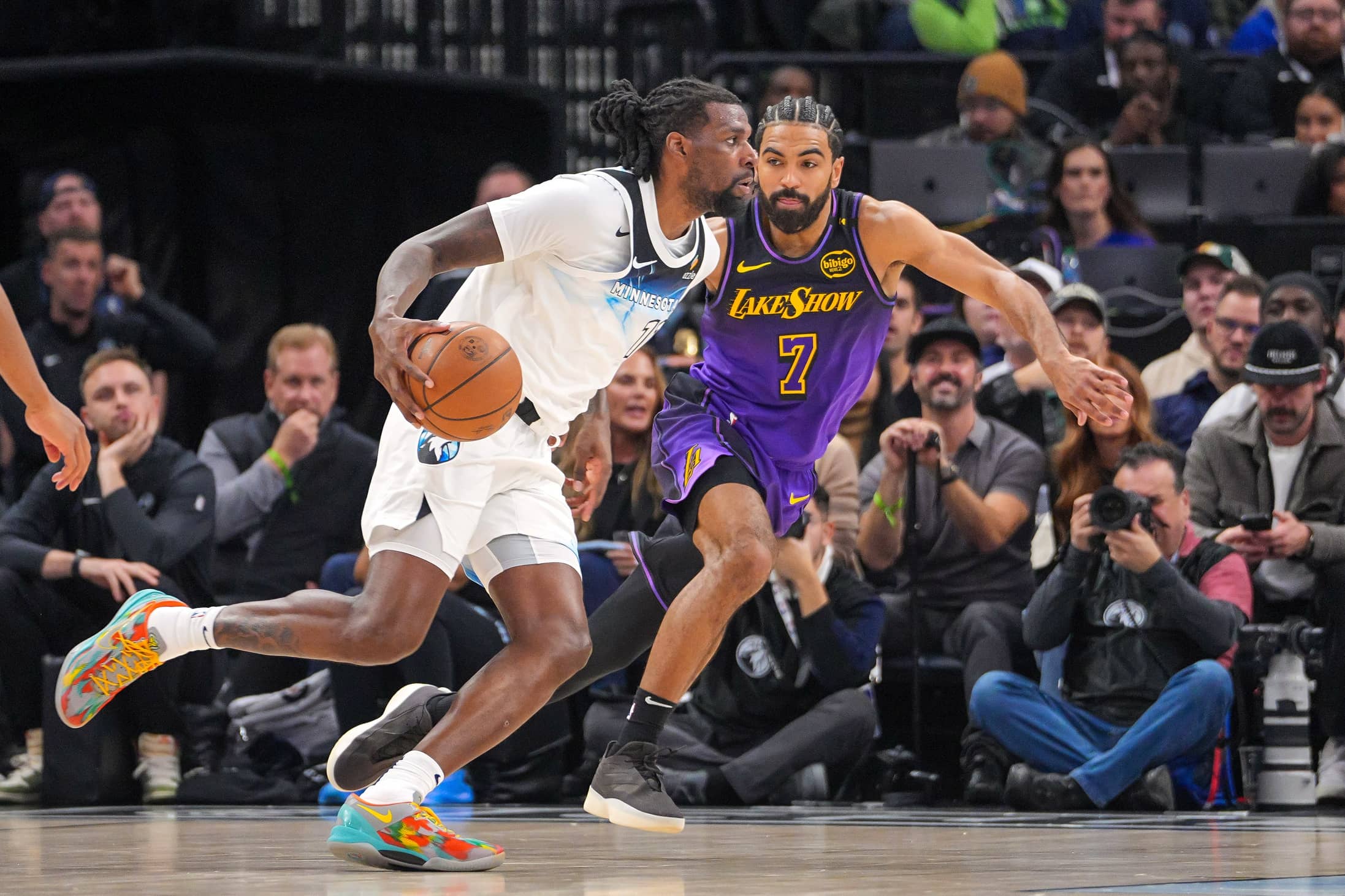 Dec 2, 2024; Minneapolis, Minnesota, USA; Minnesota Timberwolves center Naz Reid (11) dribbles against the Los Angeles Lakers guard Gabe Vincent (7) in the second quarter at Target Center. Mandatory Credit: Brad Rempel-Imagn Images
